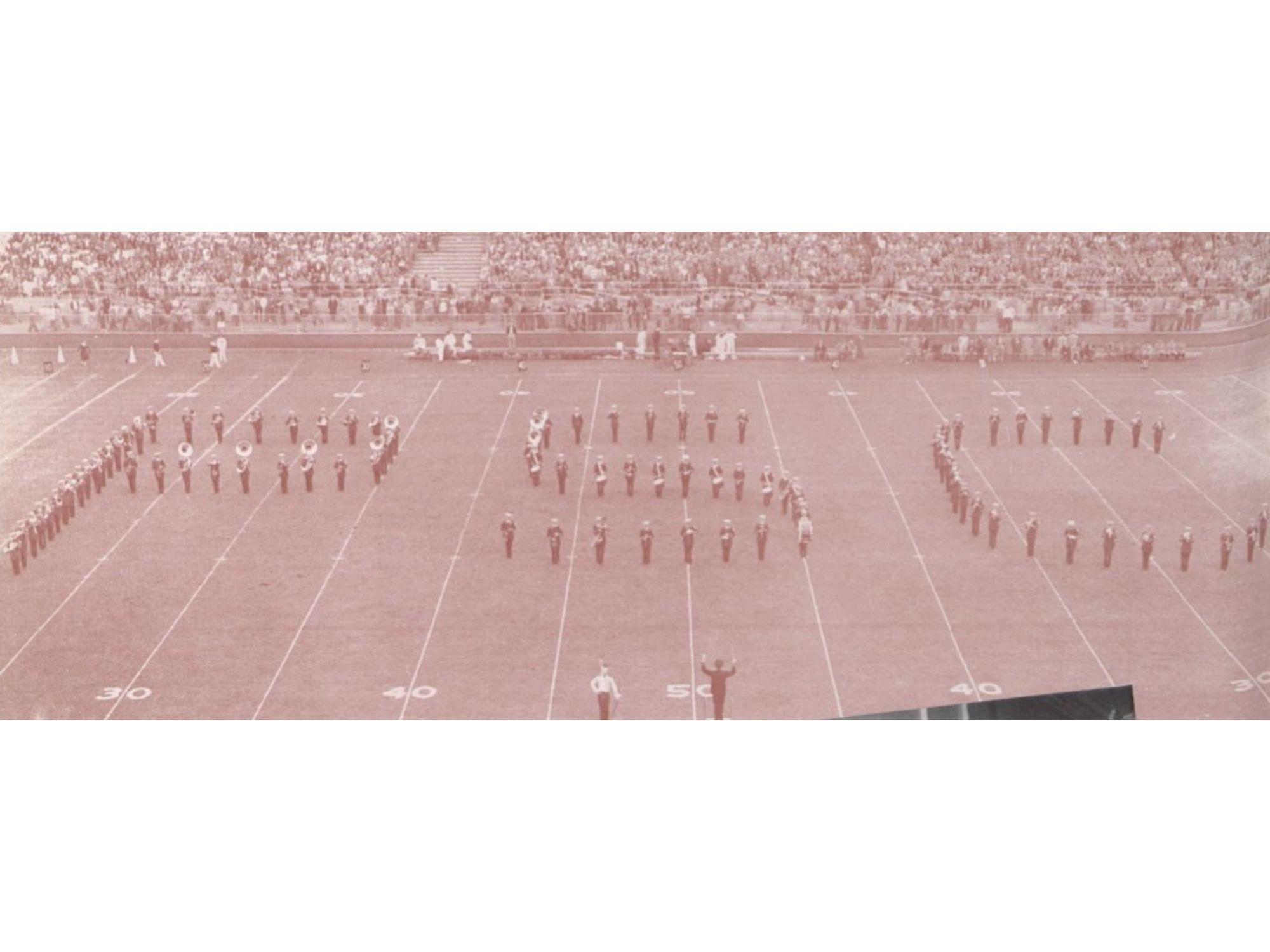 A band forms "PSC" on a football field