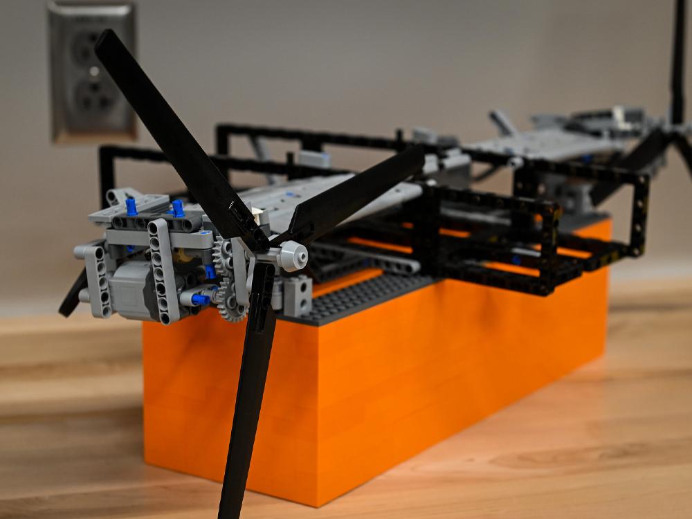  A black, orange and silver LEGO model of a vertical flight vehicle