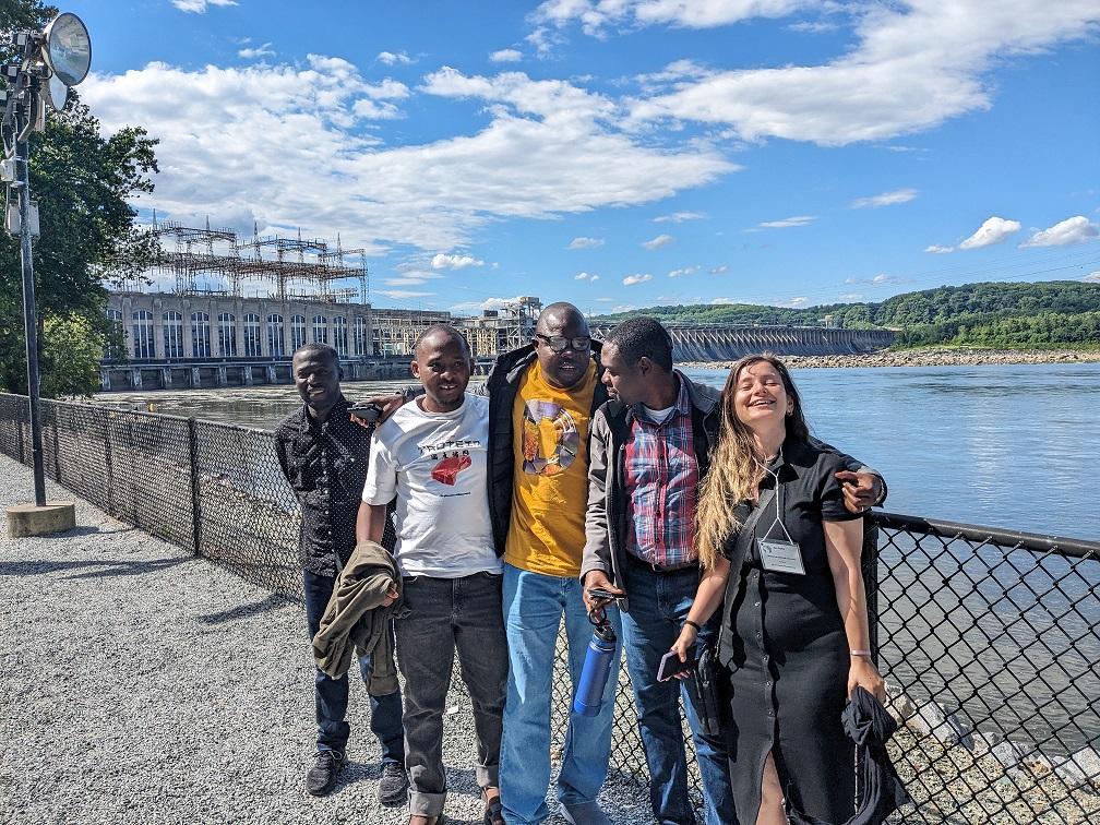 People standing in front of water. 
