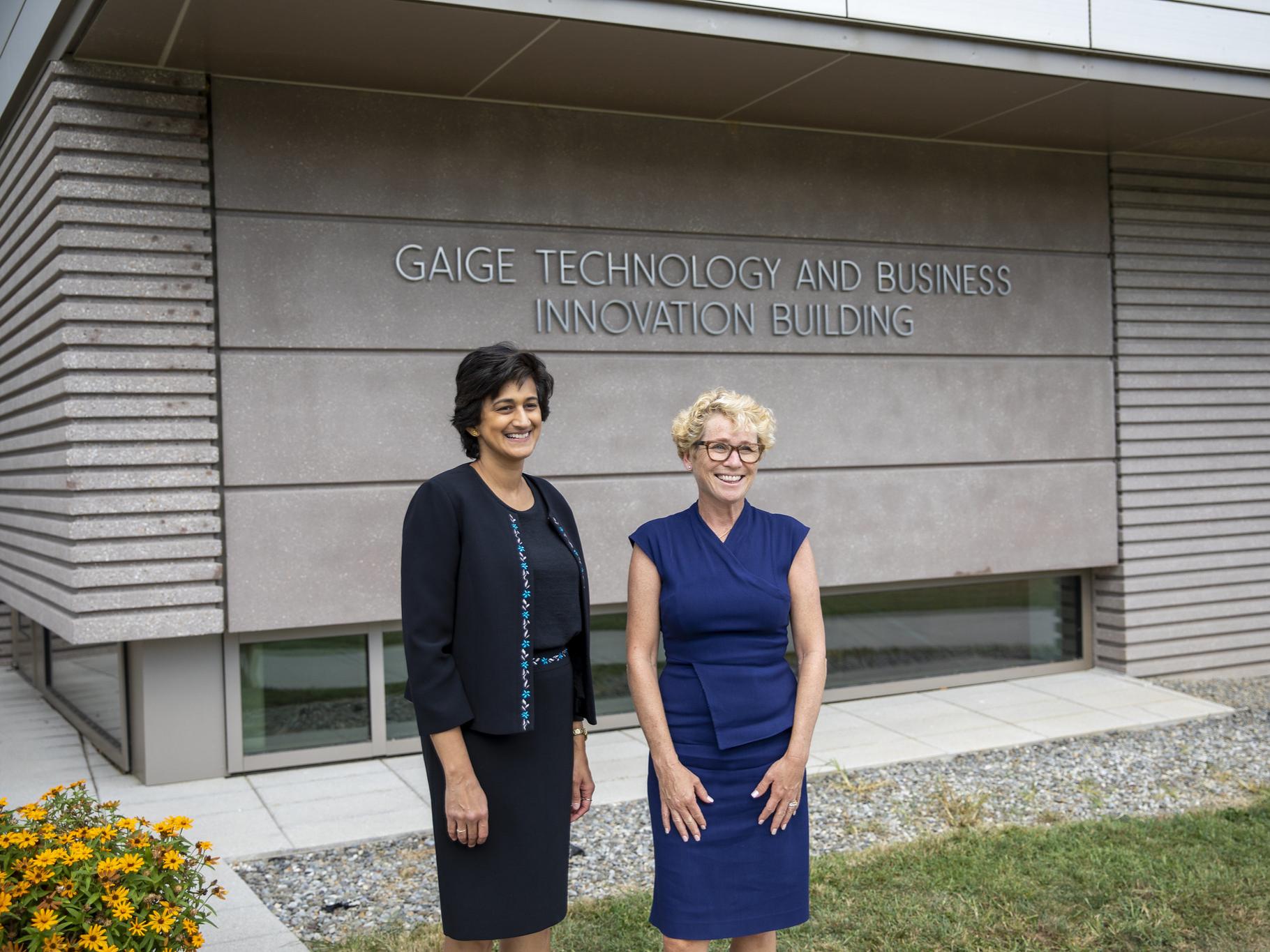 Chancellor Pyati and Rep. Houlahan pose in front of the Gaige Technology and Business Innovation Building sign