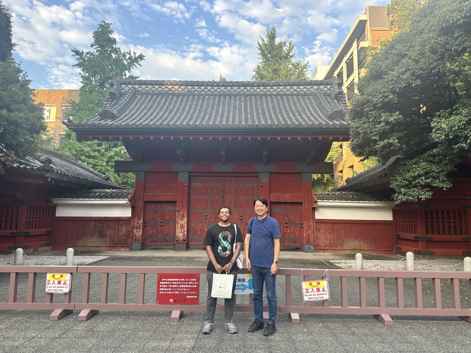 Two individuals stand in front of a building in Tokyo