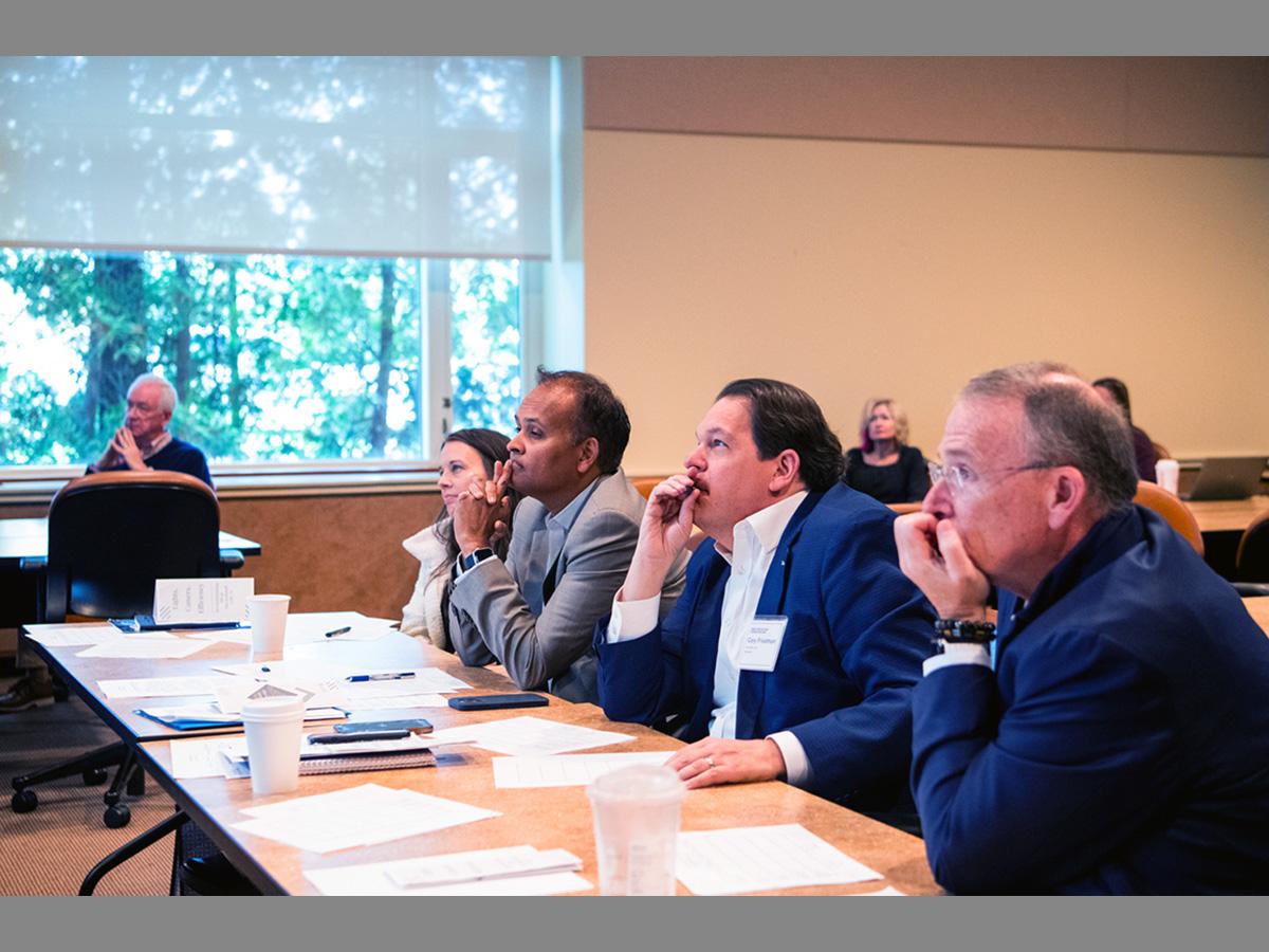 Judges for the HR case competition listening to presentations from students
