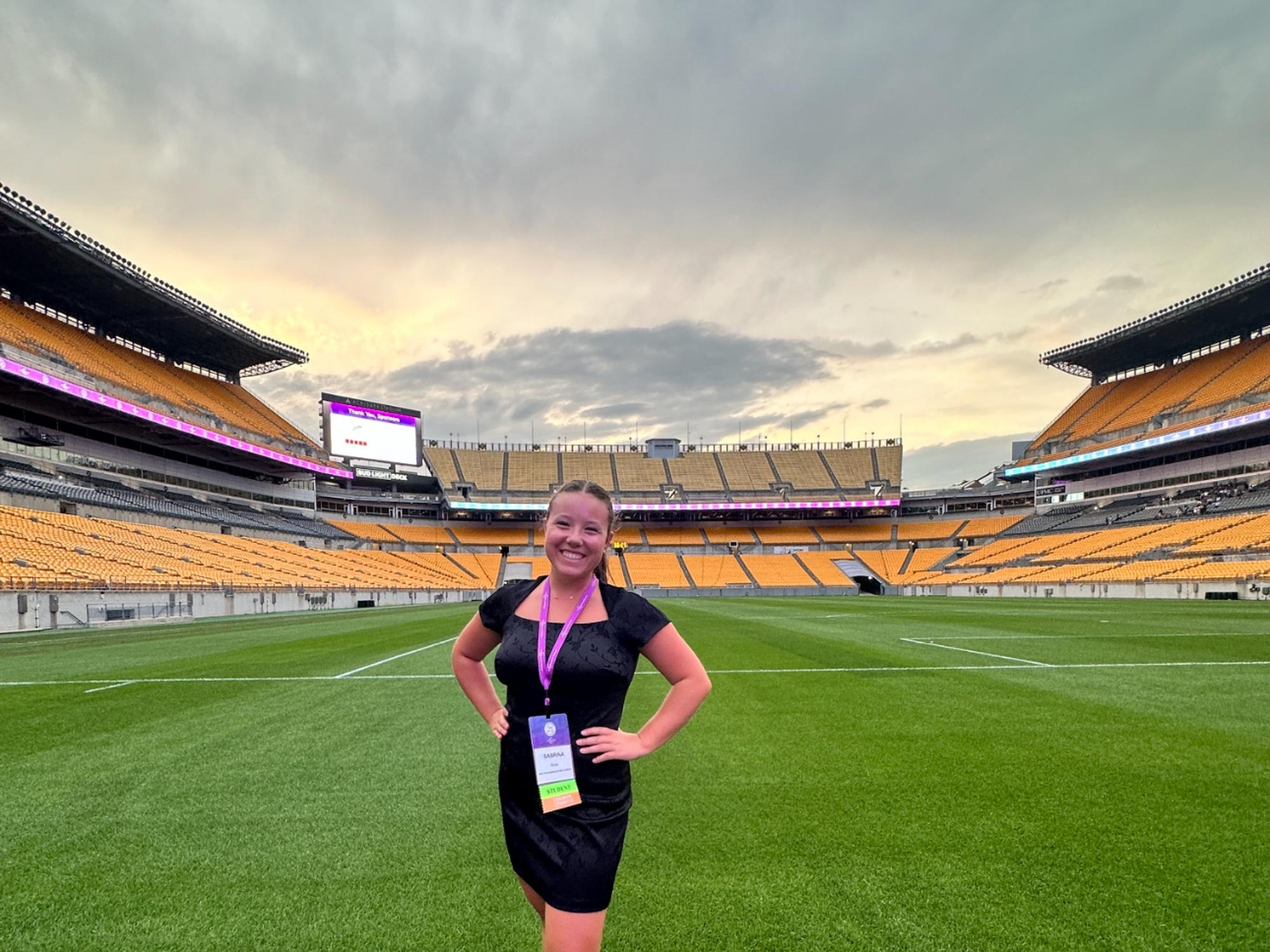 Sabrina Knox stands on the field in Acrisure Stadium in Pittsburgh.