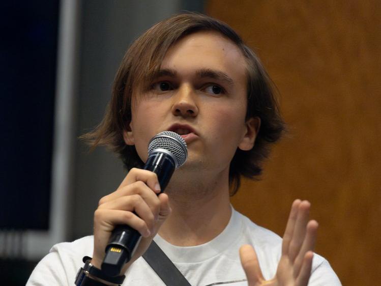 Gwynne Morris speaks into a microphone while wearing a Penn State T-shirt.