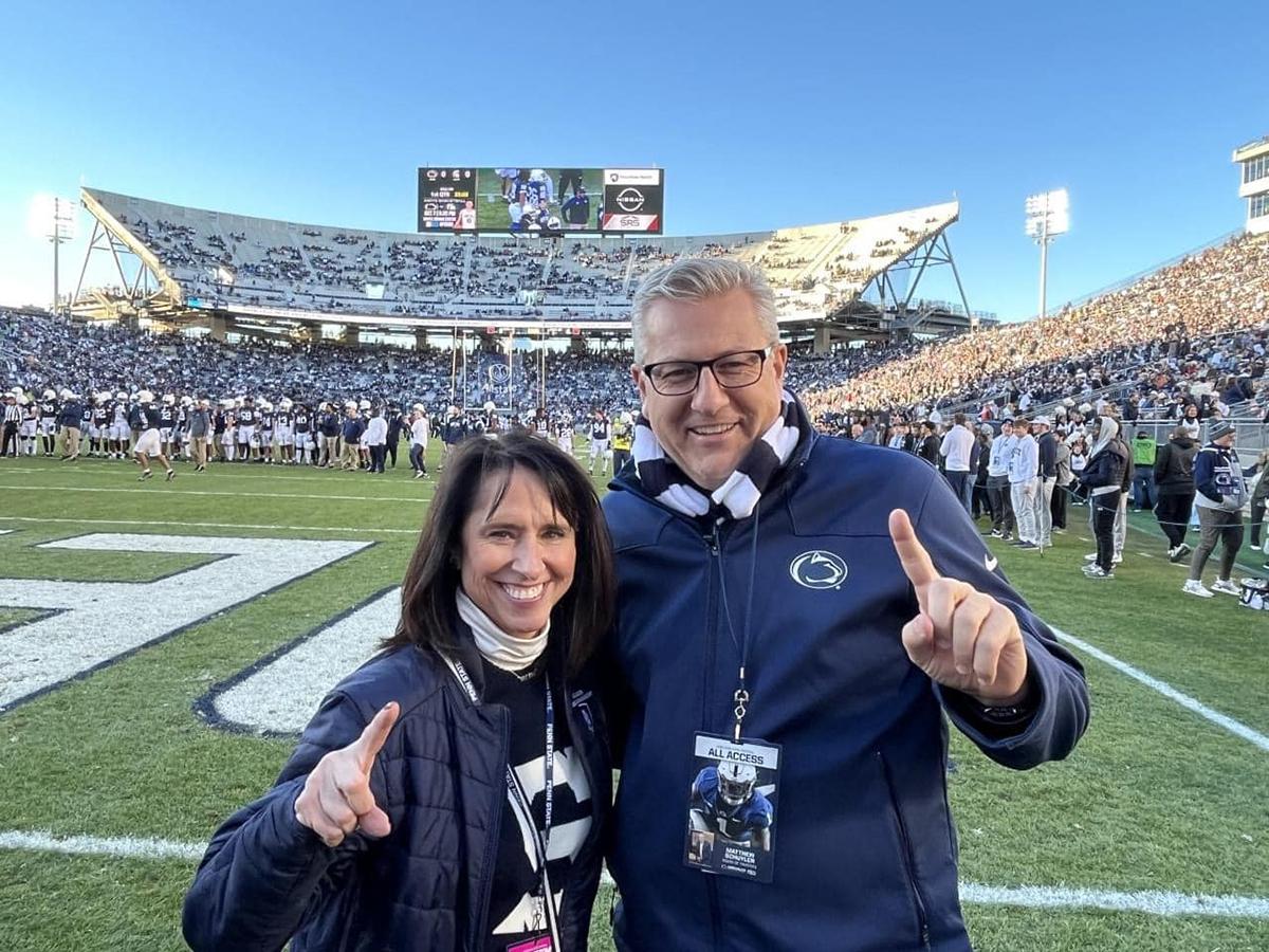 Matt Schuyler and Kelly Lynch pose on the field at Beaver Stadium