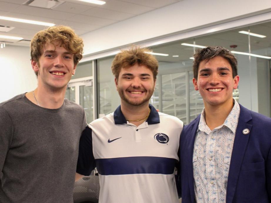 Hunter Steach stands between two other students at a recent UPUA General Assembly meeting in the HUB-Robeson Center.