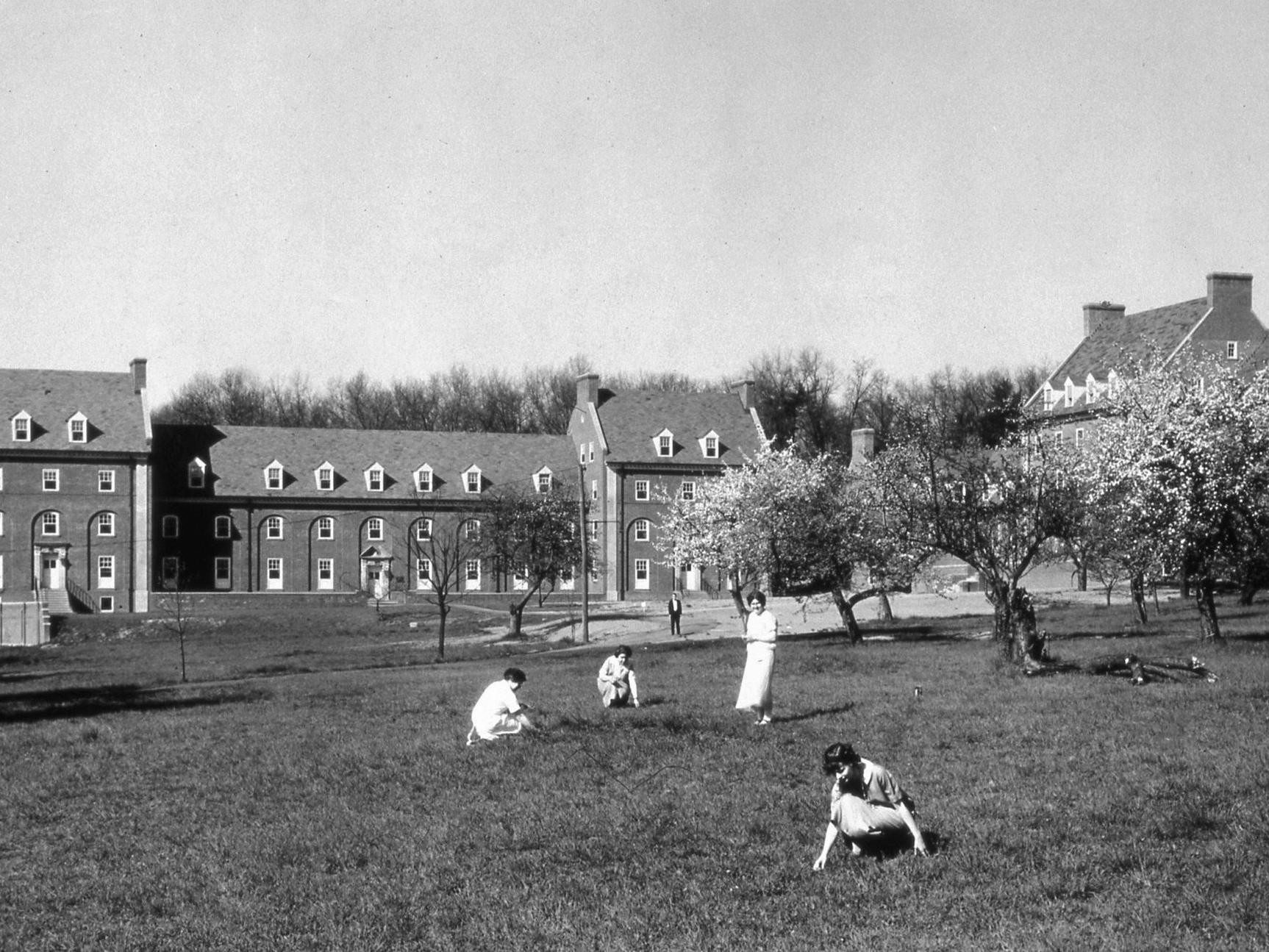 West Halls in 1924, with several students on the grass in the foreground