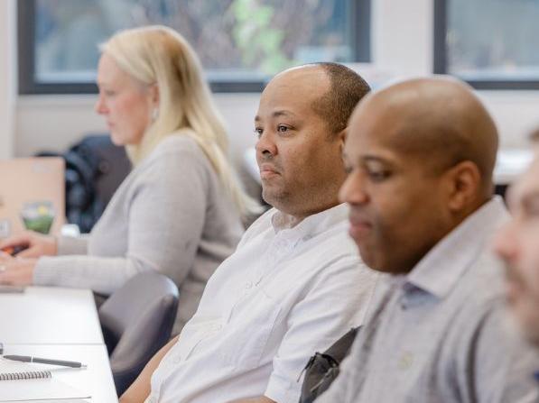 Participants sitting at a table during the Boots to Business Reboot