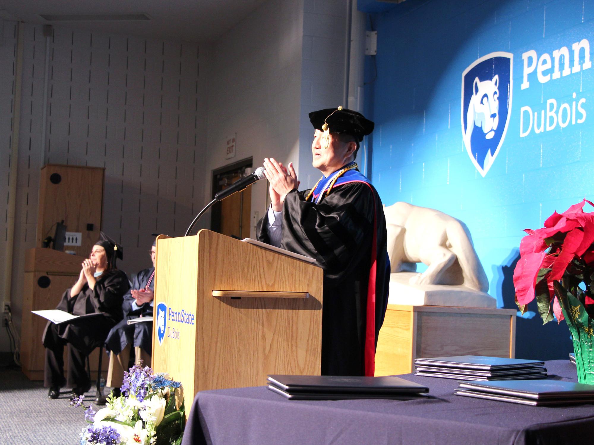Jungwoo Ryoo, chancellor and chief academic officer, leads a round of applause for parents and family members who supported the graduates during the fall 2024 commencement celebration at Penn State DuBois.