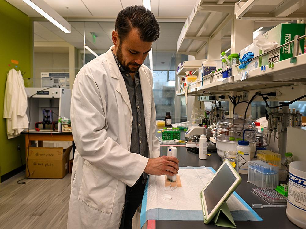  individual wearing white lab coat working in a lab