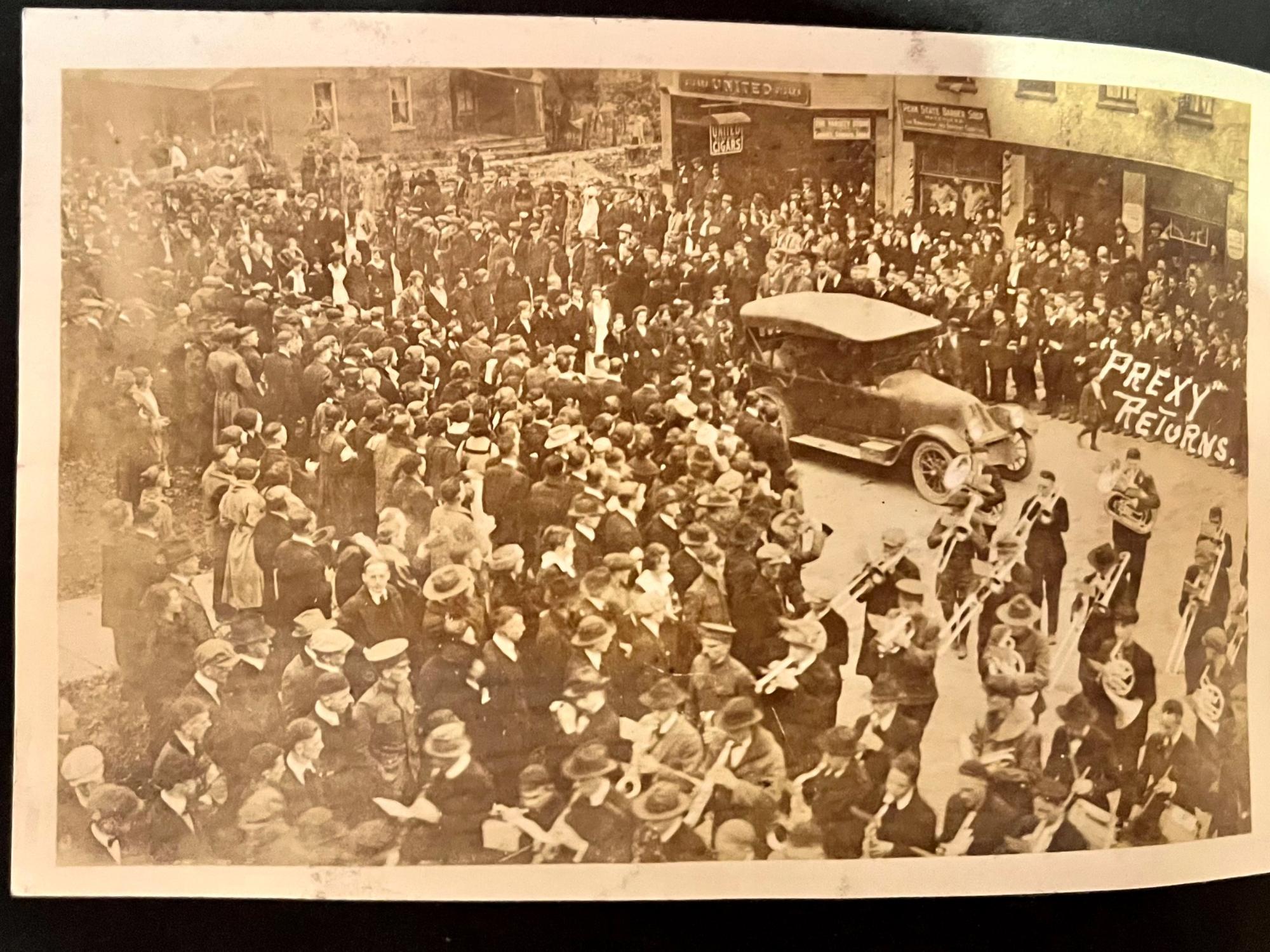 A crowd lines the streets in the early 1920s