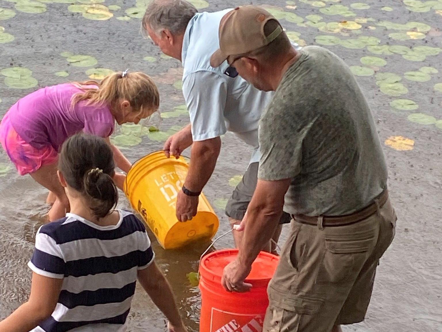 Master Watershed Steward Tim Matthews and kids stock trout