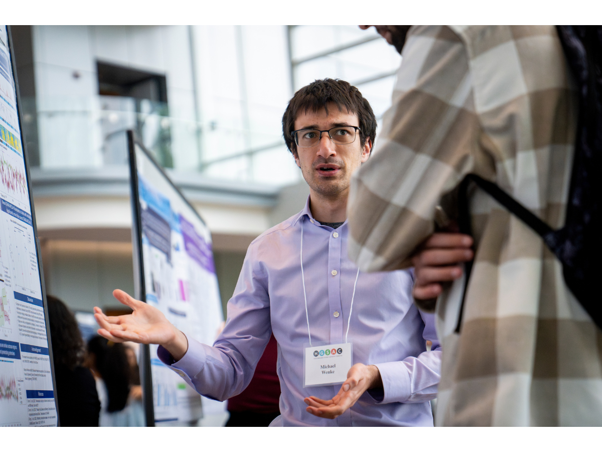 Person presenting at a poster. 