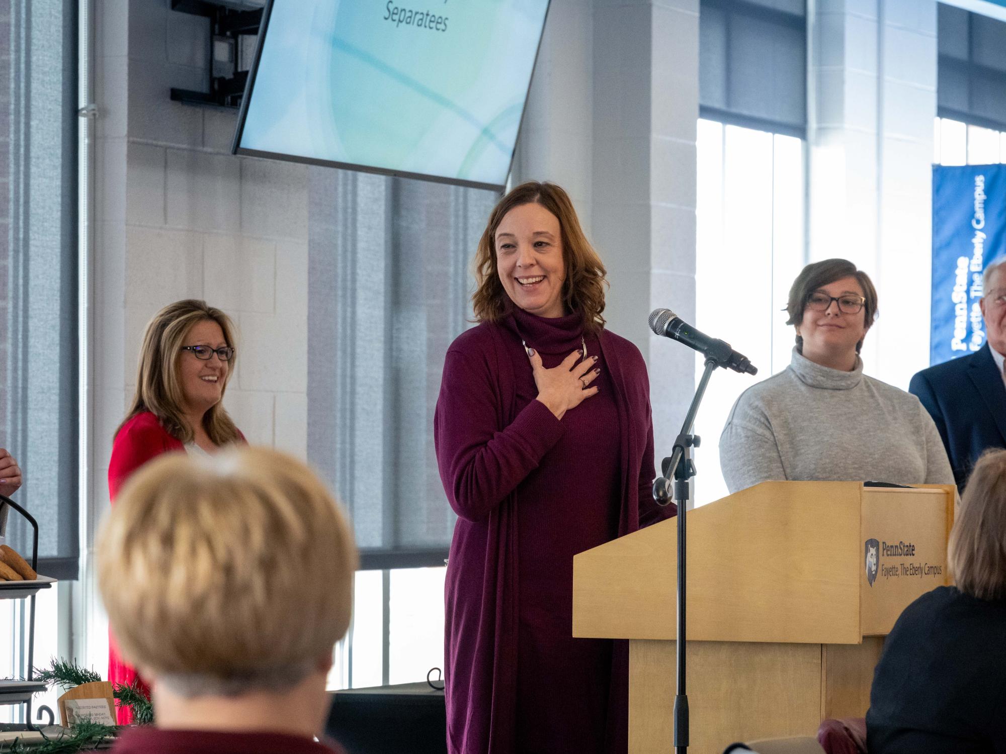 Alison Hawk speaks at the podium after receiving her Faculty Excellence in Teaching Award.