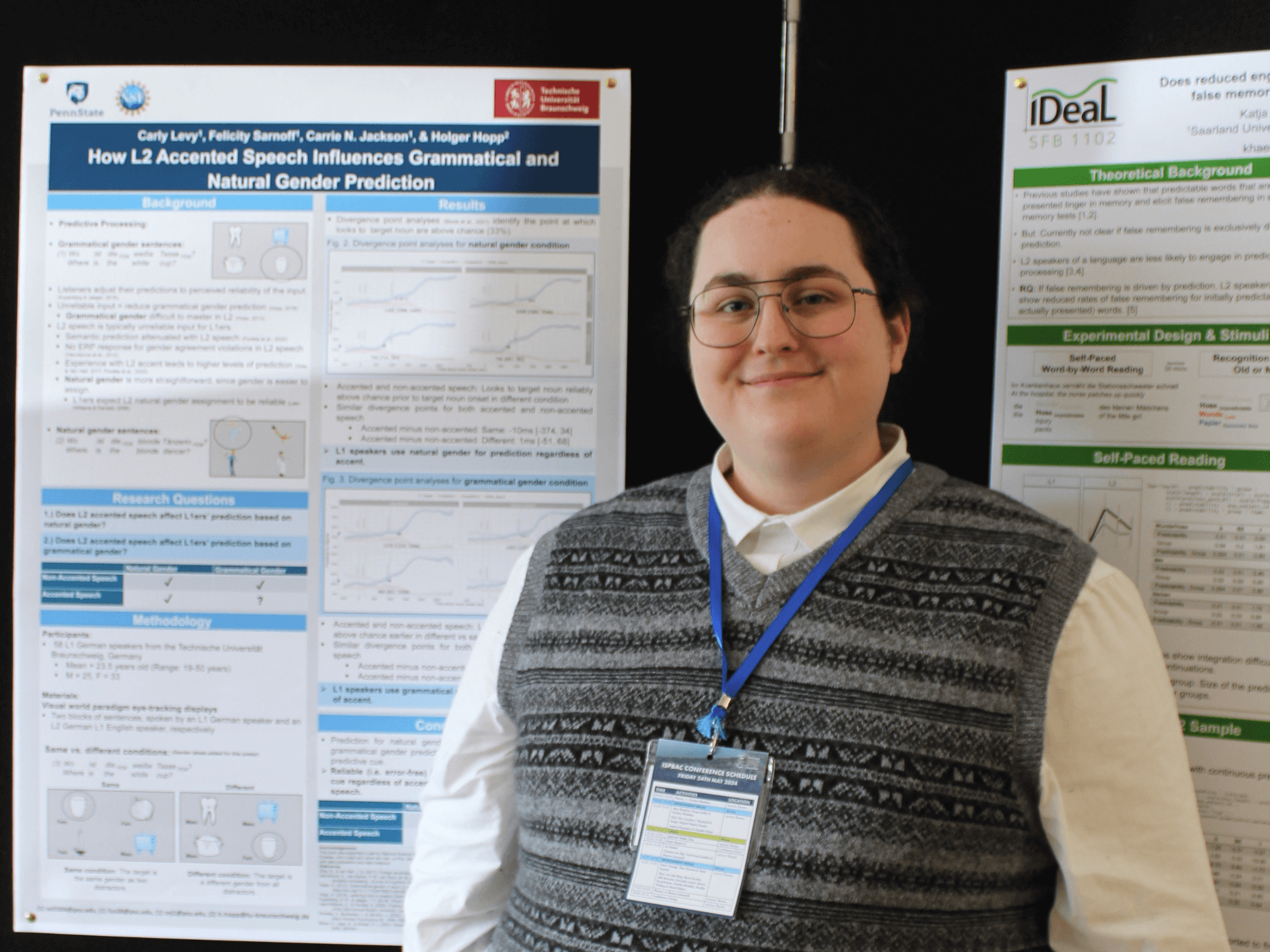 Felicity Sarnoff standing in front of research posters at a conference in Swansea, Wales