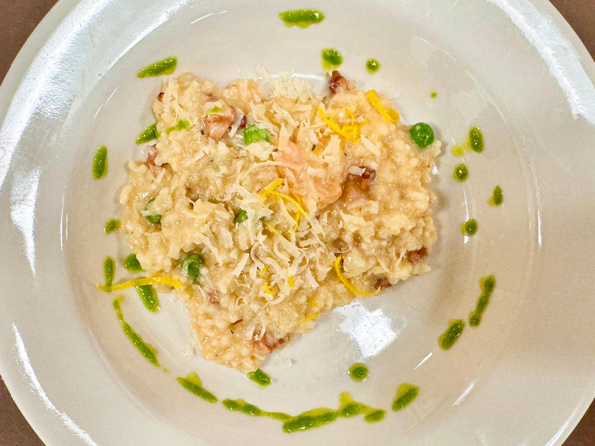 Photograph of rice dish with a shrimp and green sauce