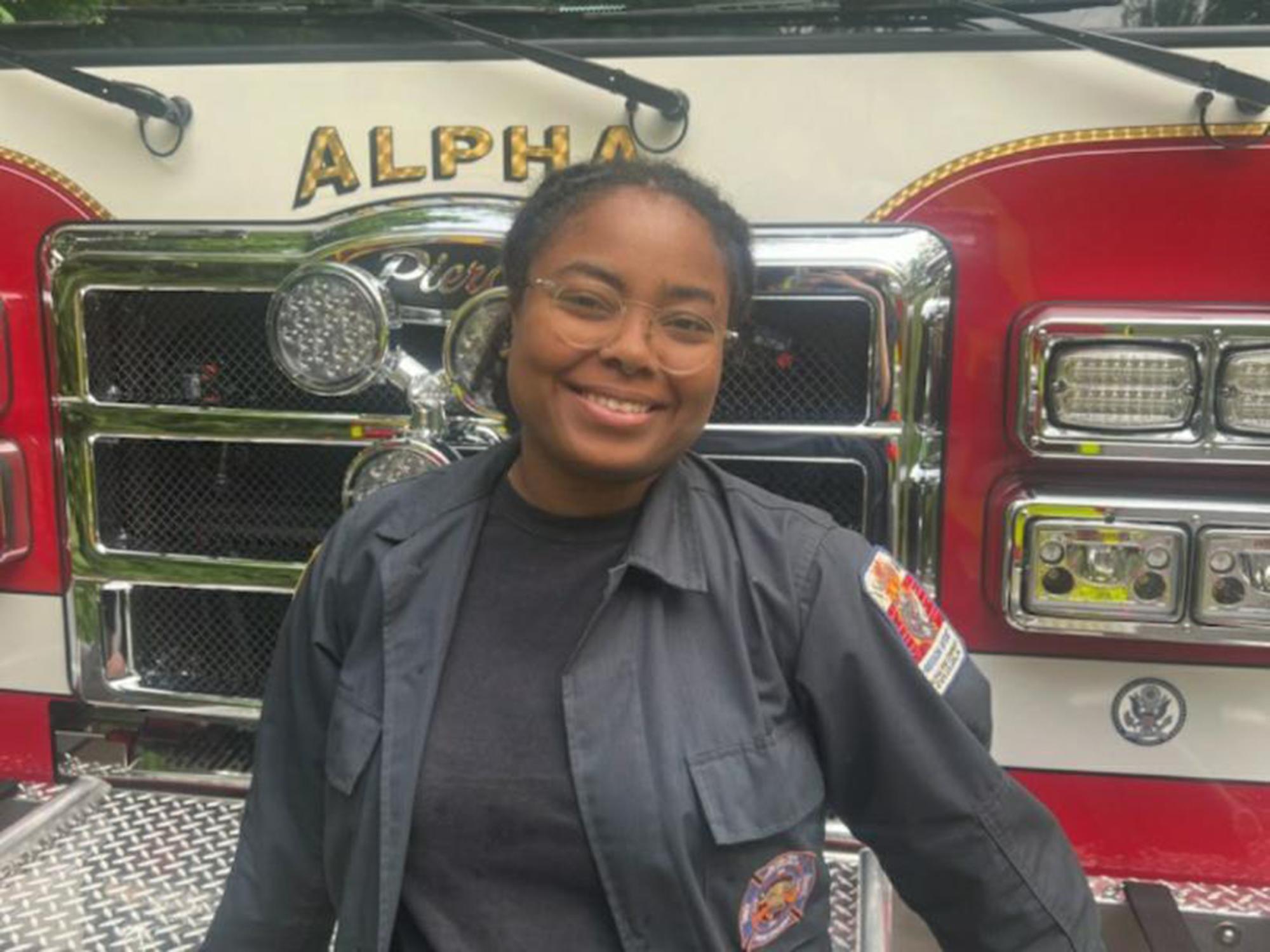 Tsunami Sharmba posting in front of a fire engine
