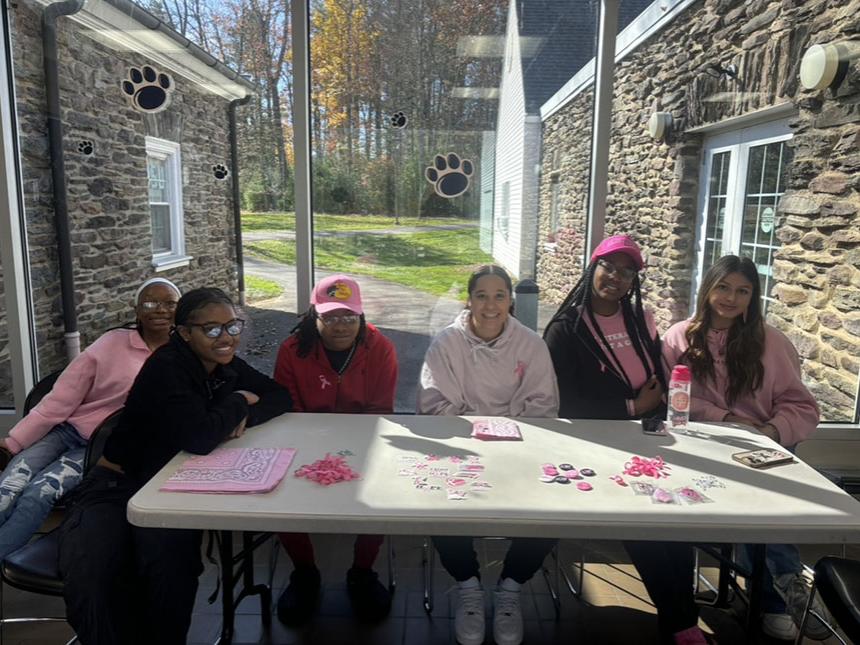 A group of people at a table in front of a winter.