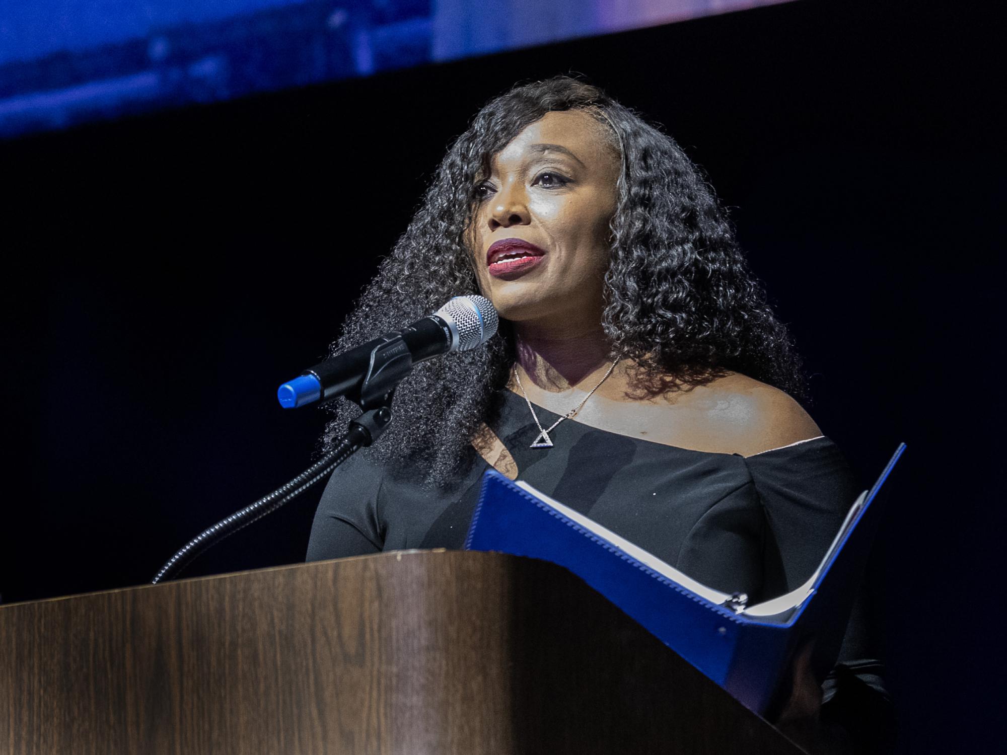 Stephanie Preston speaks at a podium