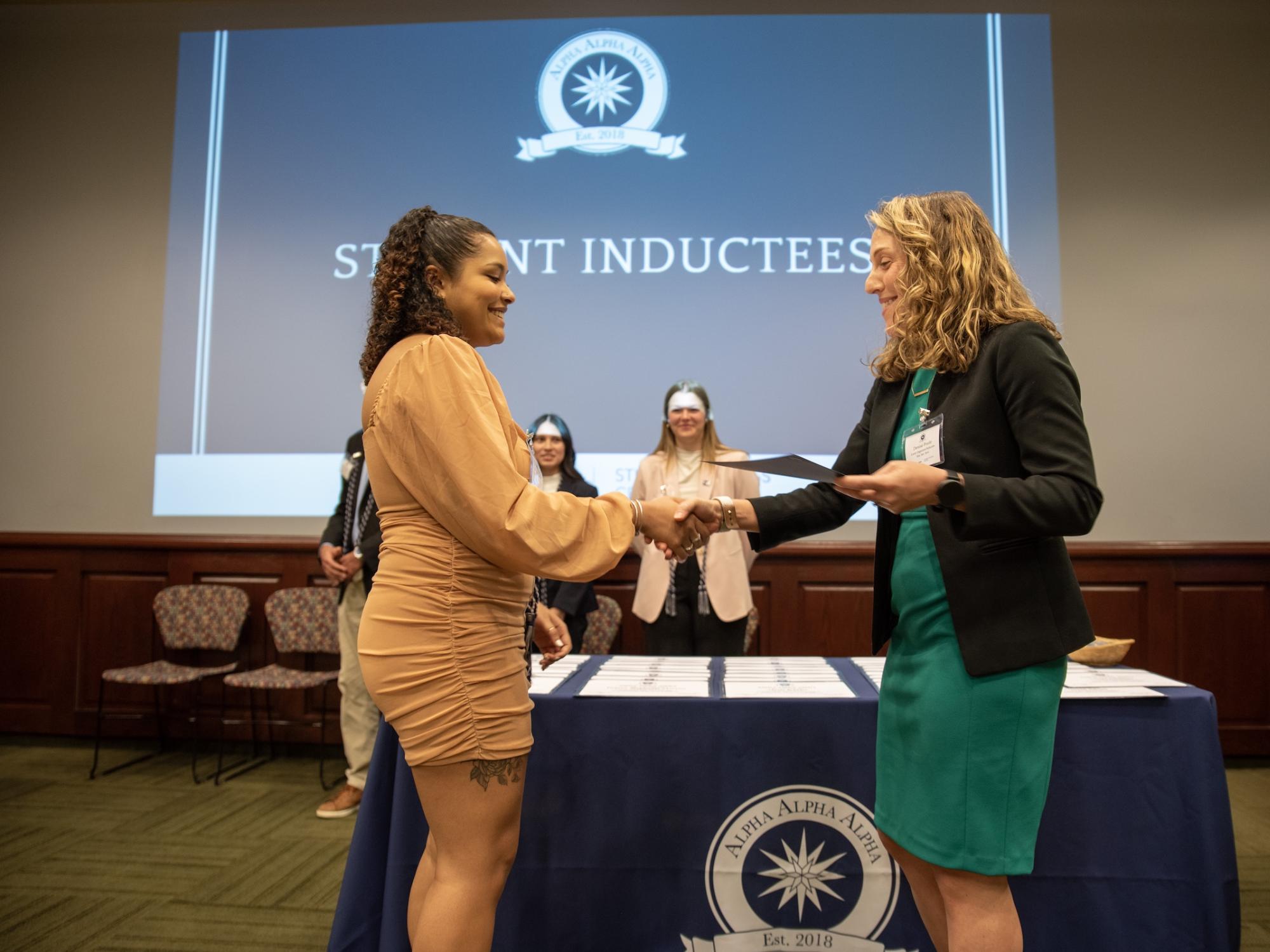 Aryana Harris accepts certificate from Denise Poole