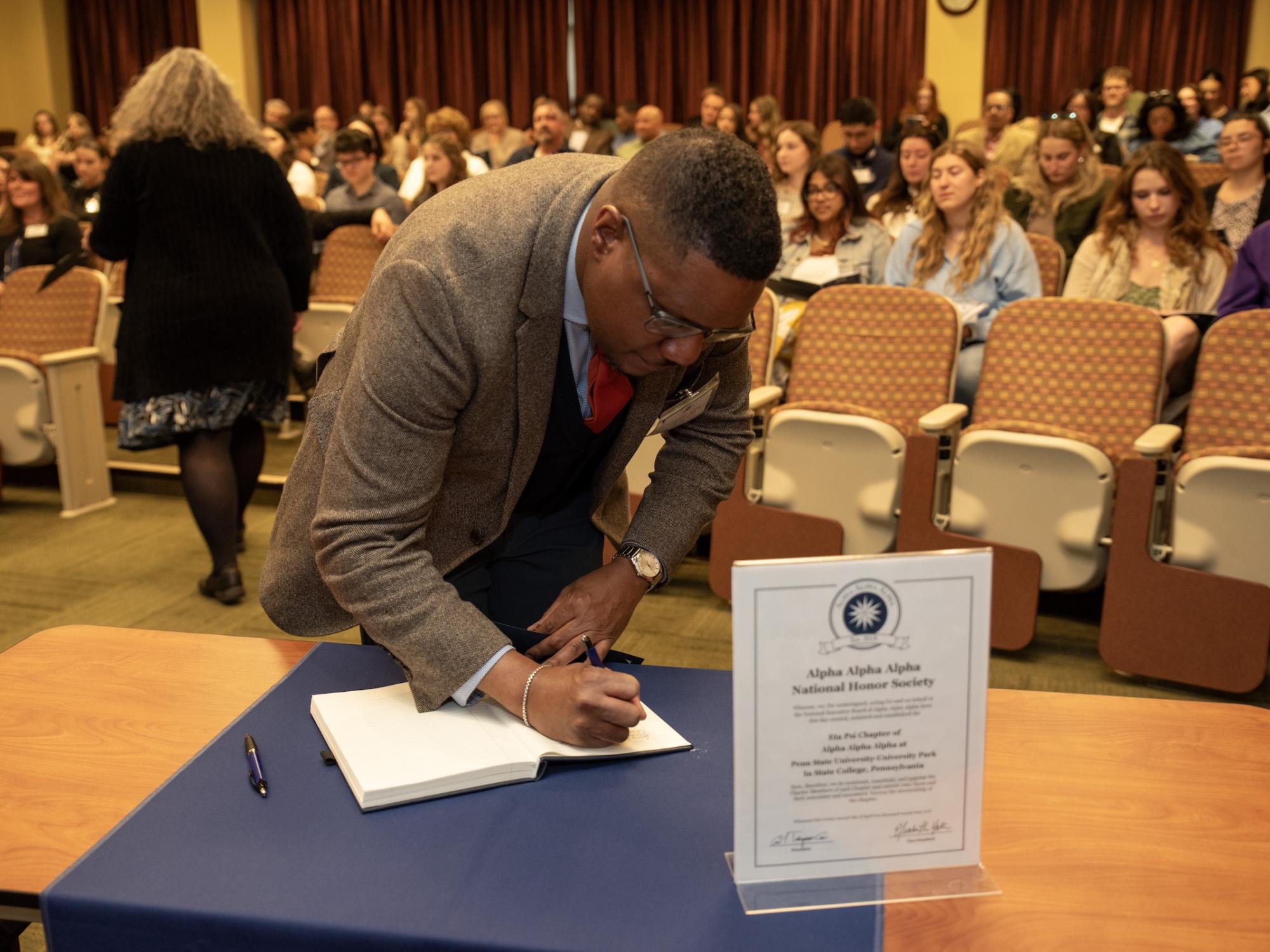 Dean Clarence Lang signing notebook