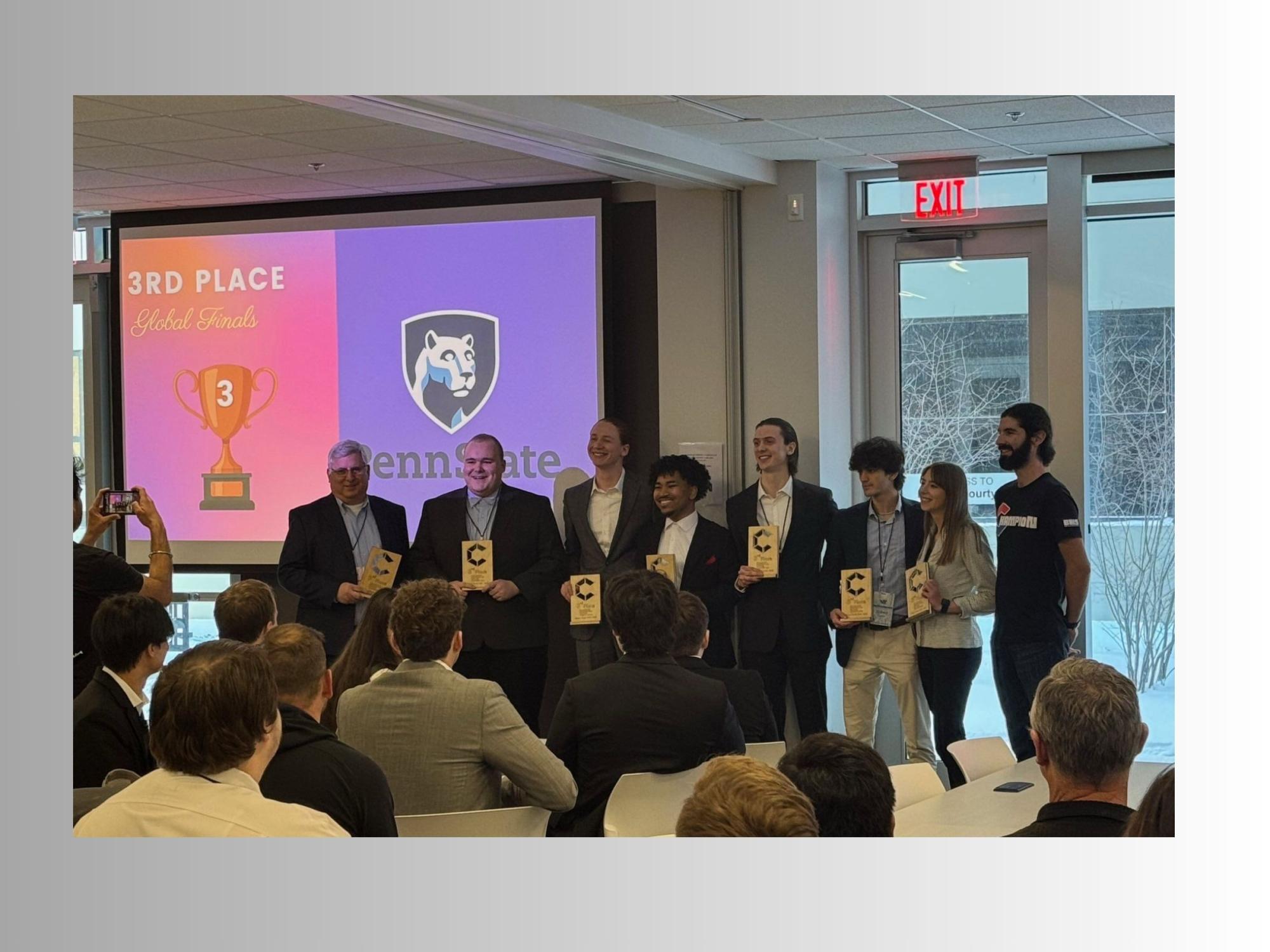 group of college students in business attire receive award at gathering