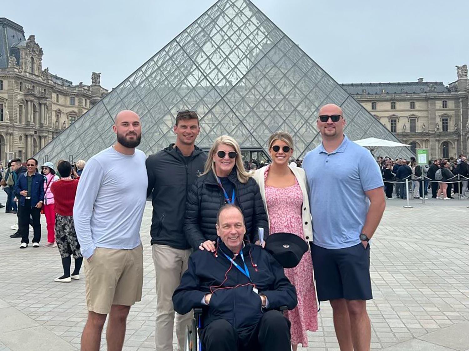 A photo of the Farrell family in front of the Louvre in Paris.