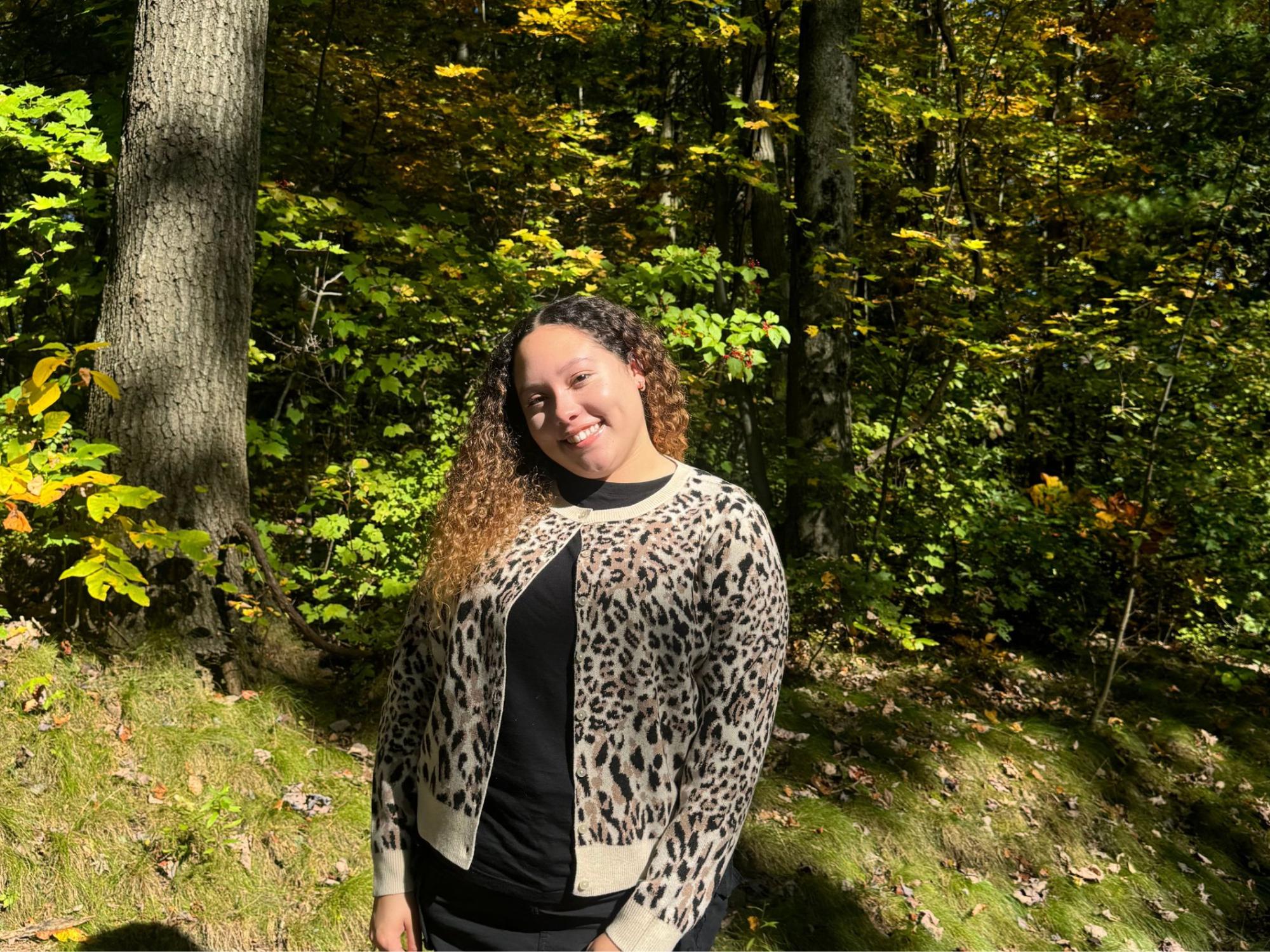 Jayden Foxx stands in front of trees.