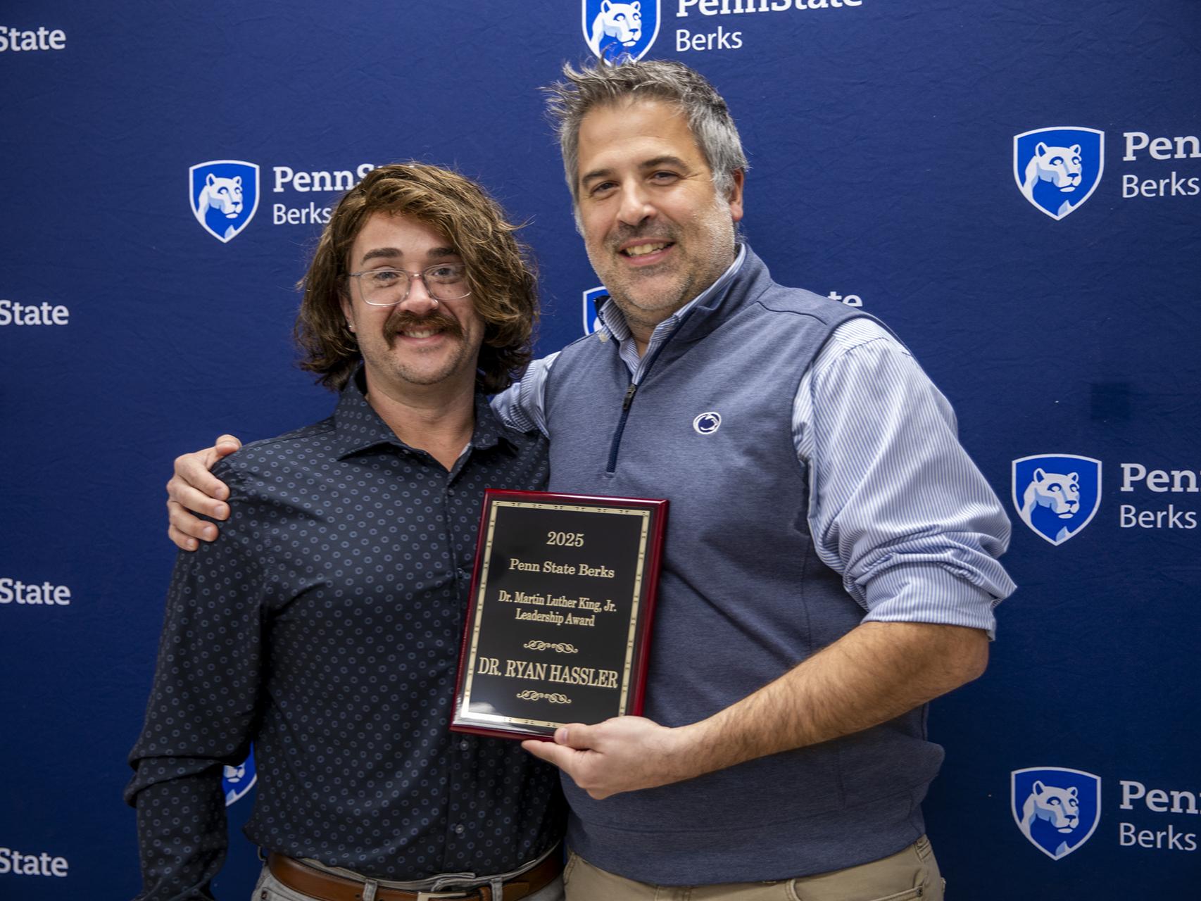 Ryan Hassler is pictured with his award