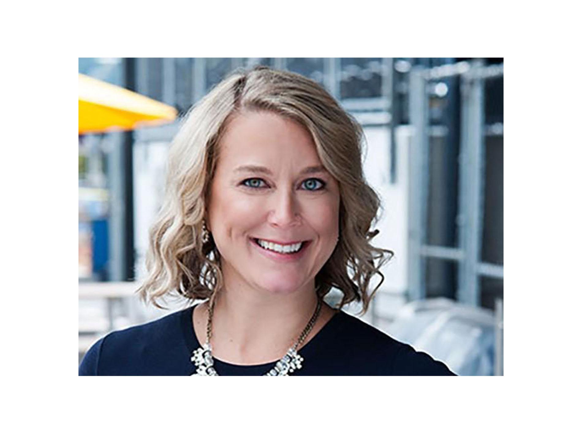 Smiling woman with short blonde hair