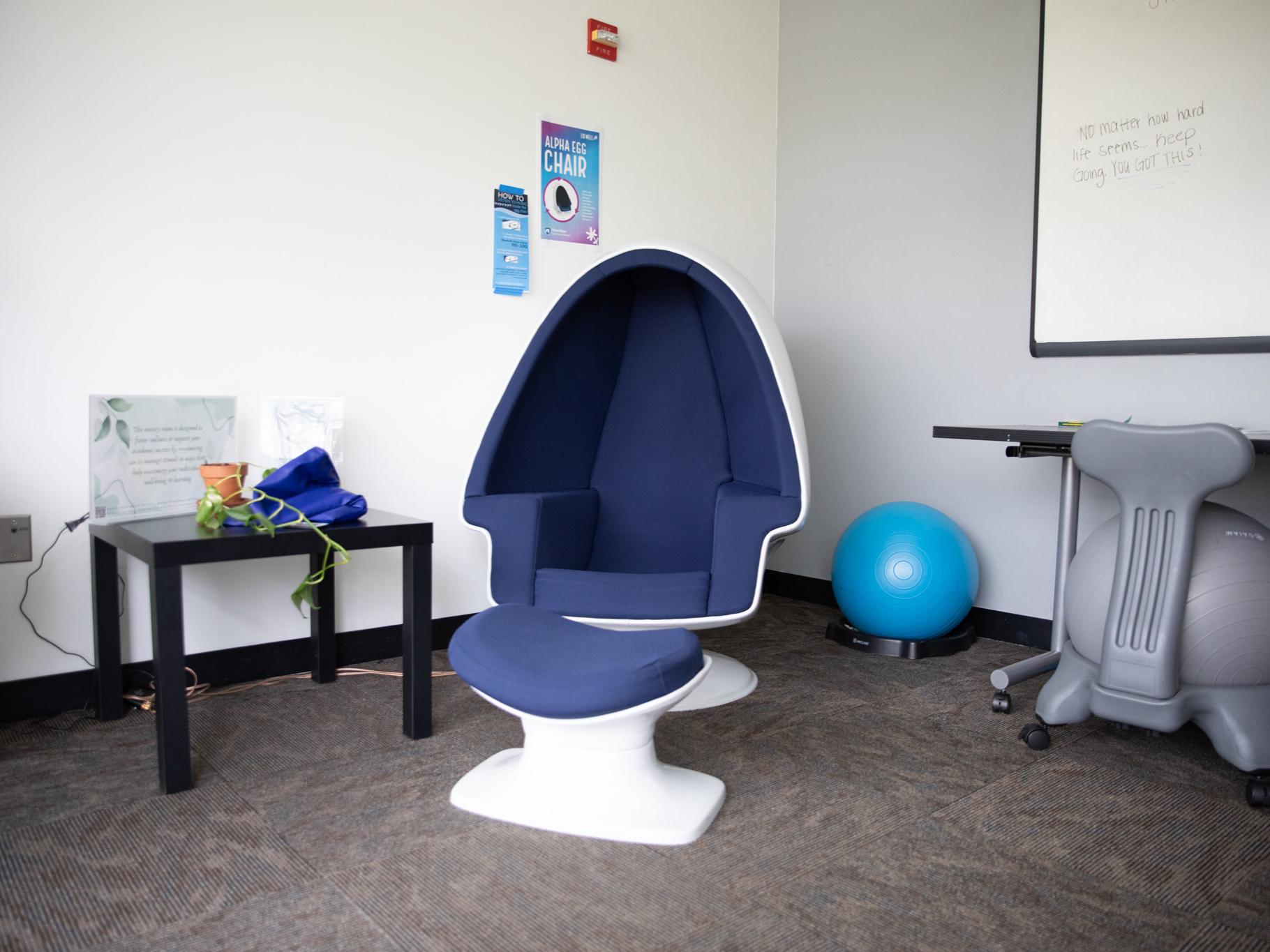 An egg-shaped chair and medicine balls sit in a quiet place.