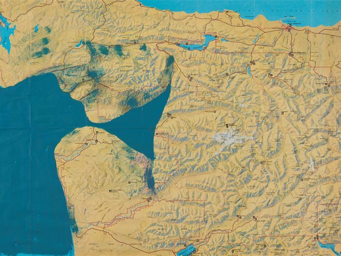 Topographic artwork of a map with the profile of a person