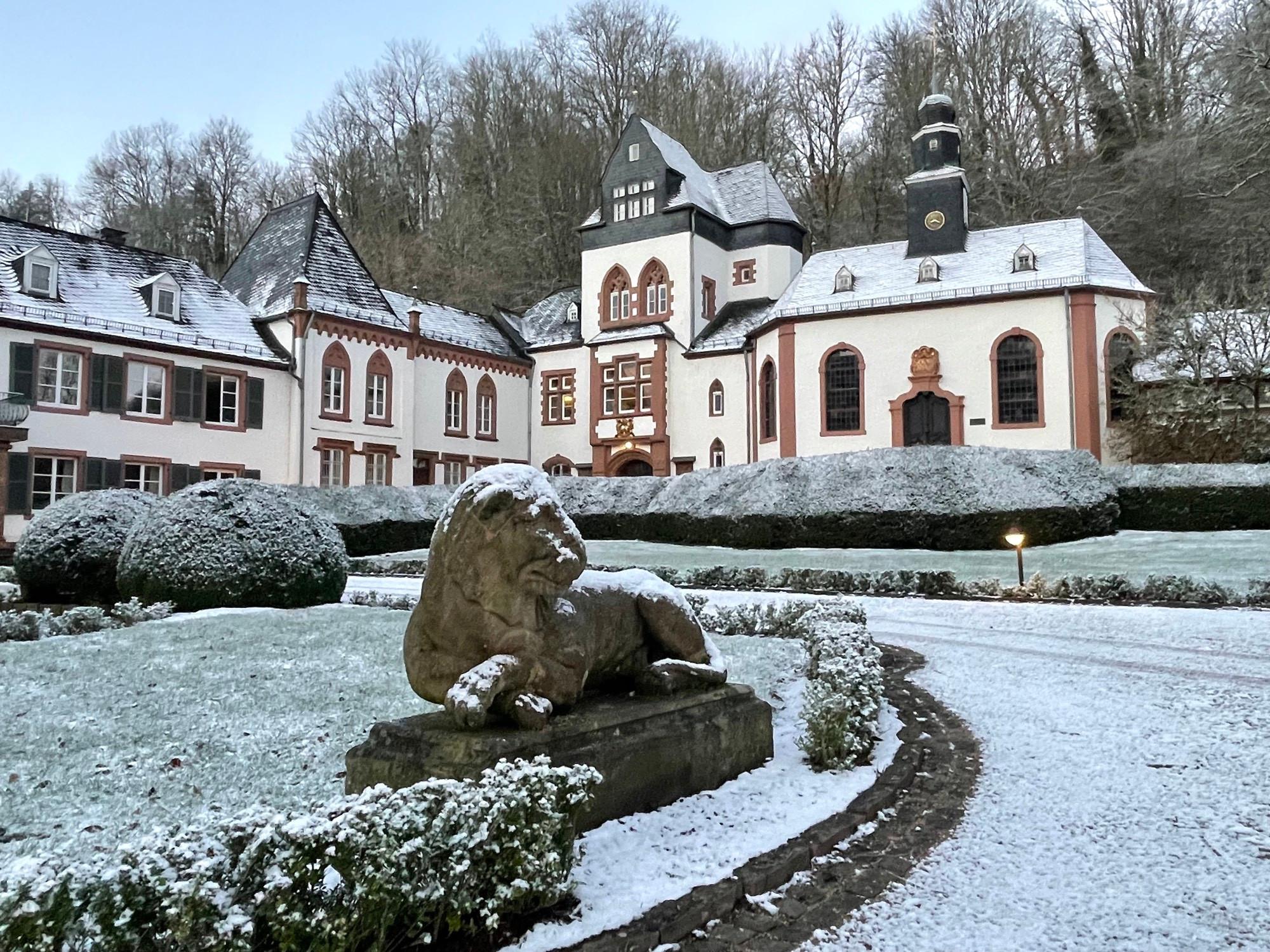 German castle behind lion statue