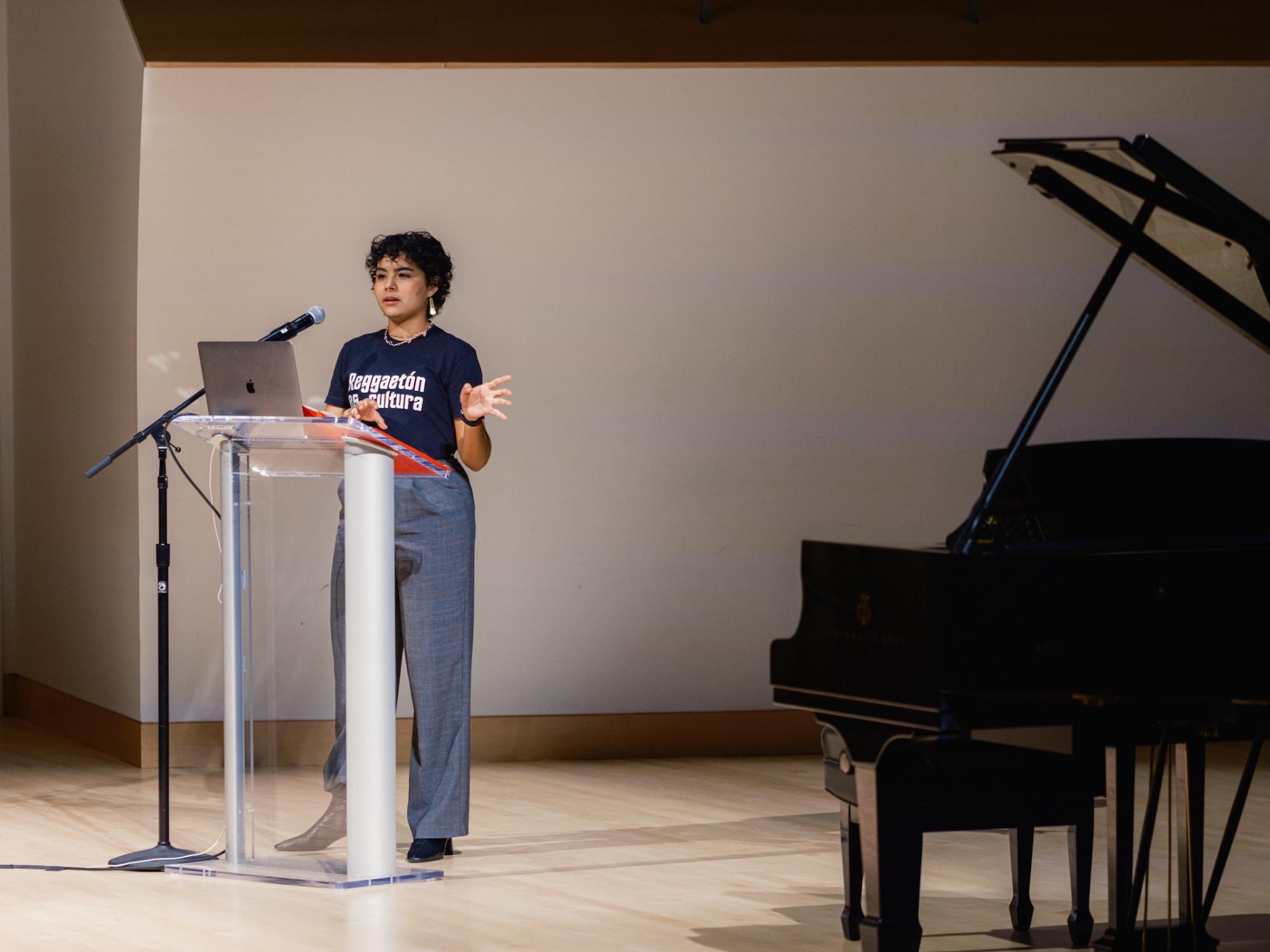 Student presenting behind podium on stage