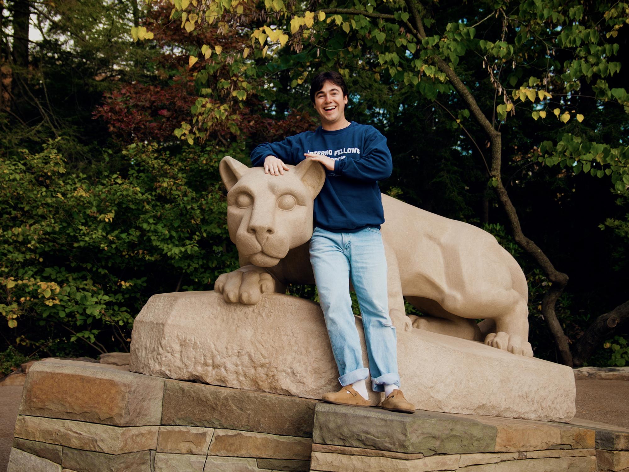 Owen Perry stands next to the Nittany Lion Shrine.