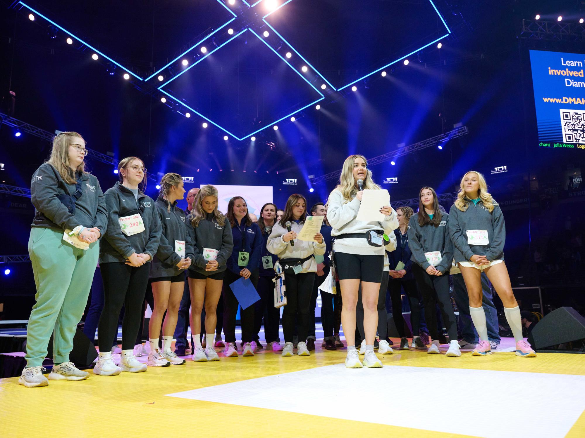 alumni dancers and volunteers on stage during THON