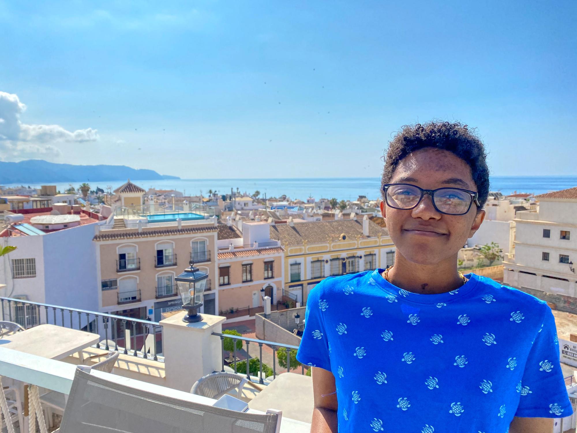 Jasmine Upchurch standing in a balcony overlooking the cityscape of Nejra, Spain.