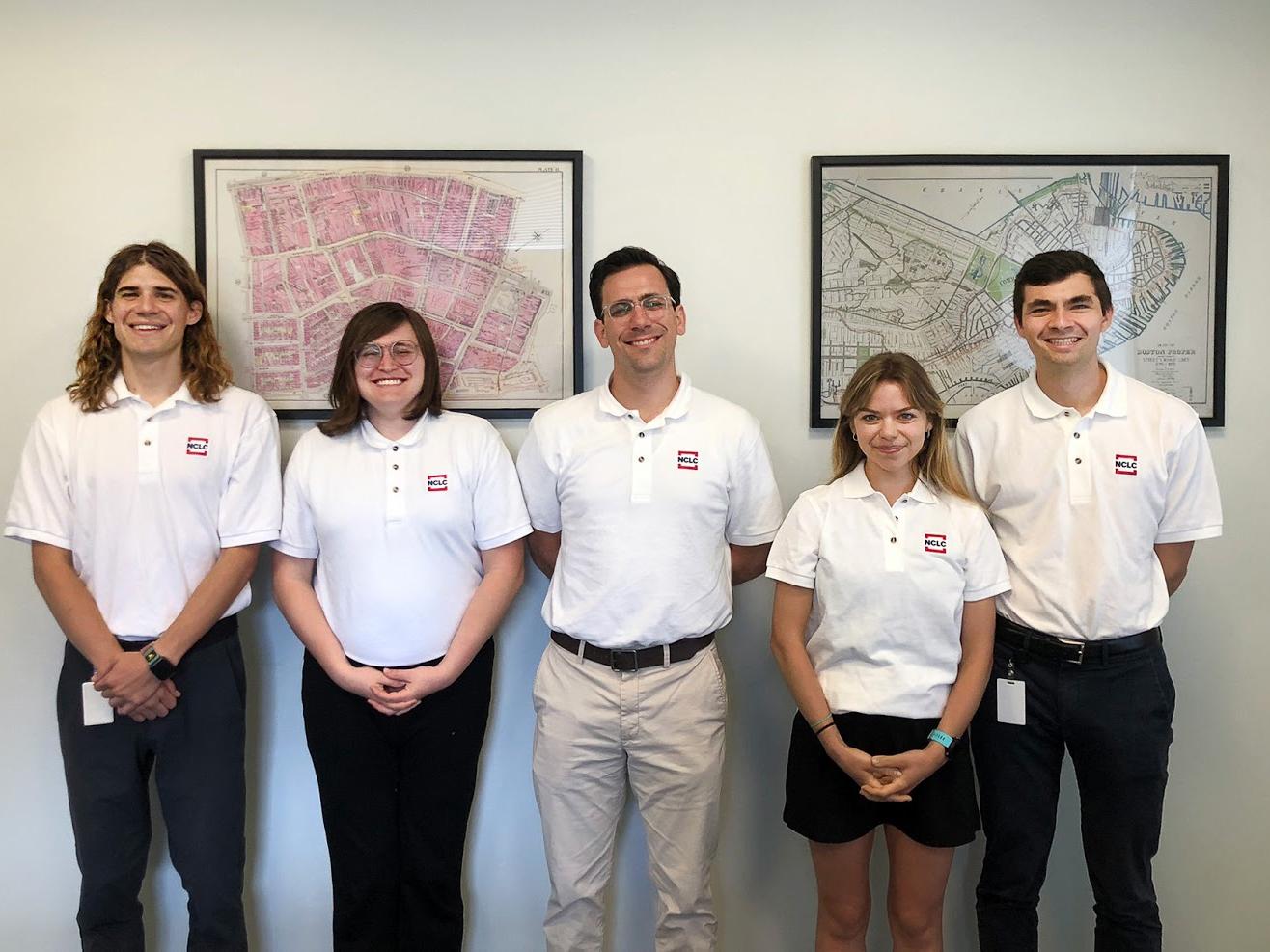 Nora Van Horn (second from right) stands in a row with four other people wearing white polos with the National Consumer Law Center logo on them.