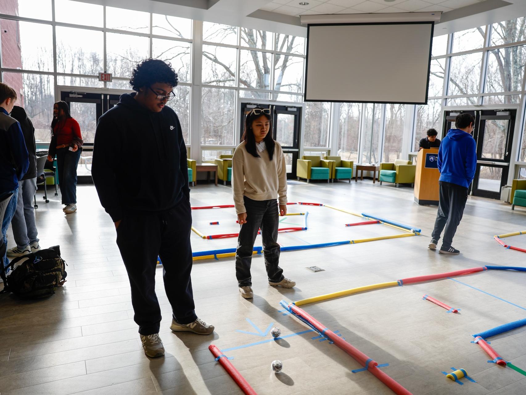 Students standing with robots