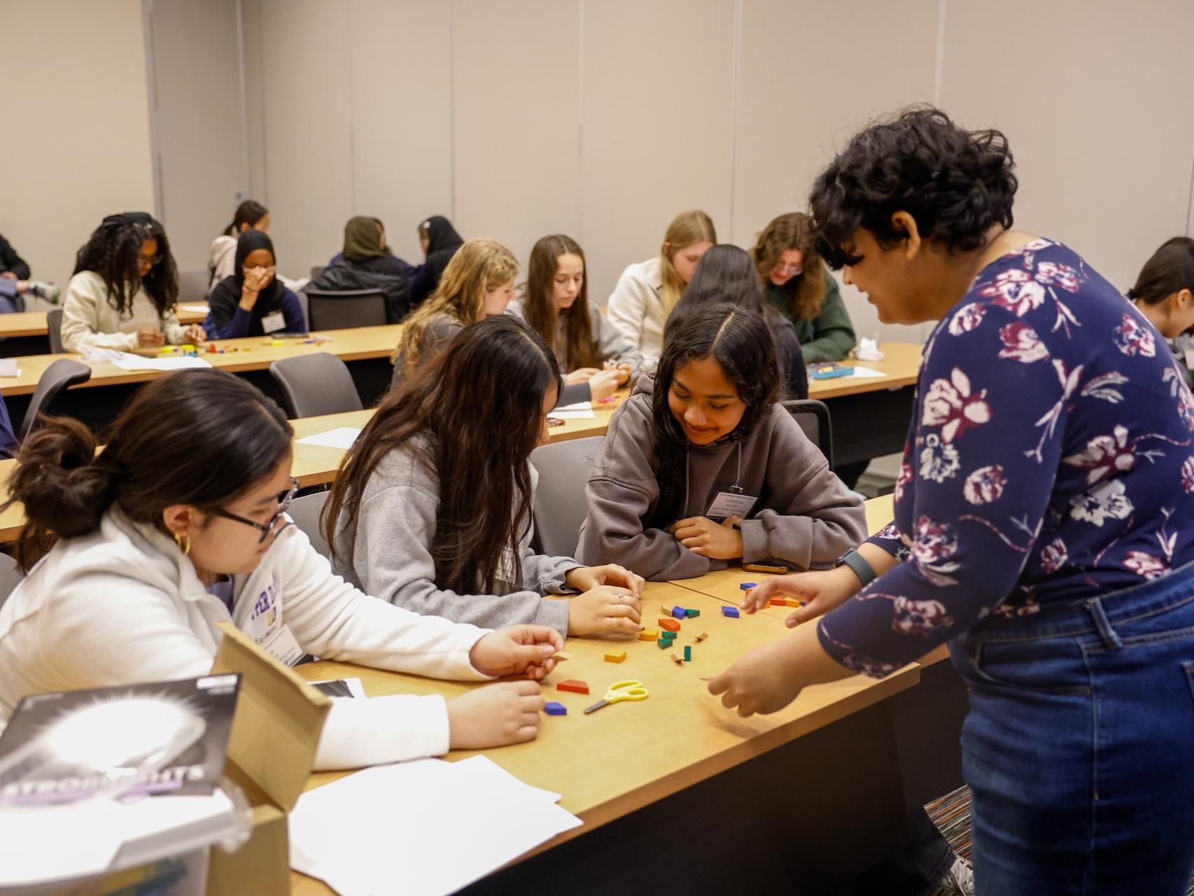 woman helping students with workshop