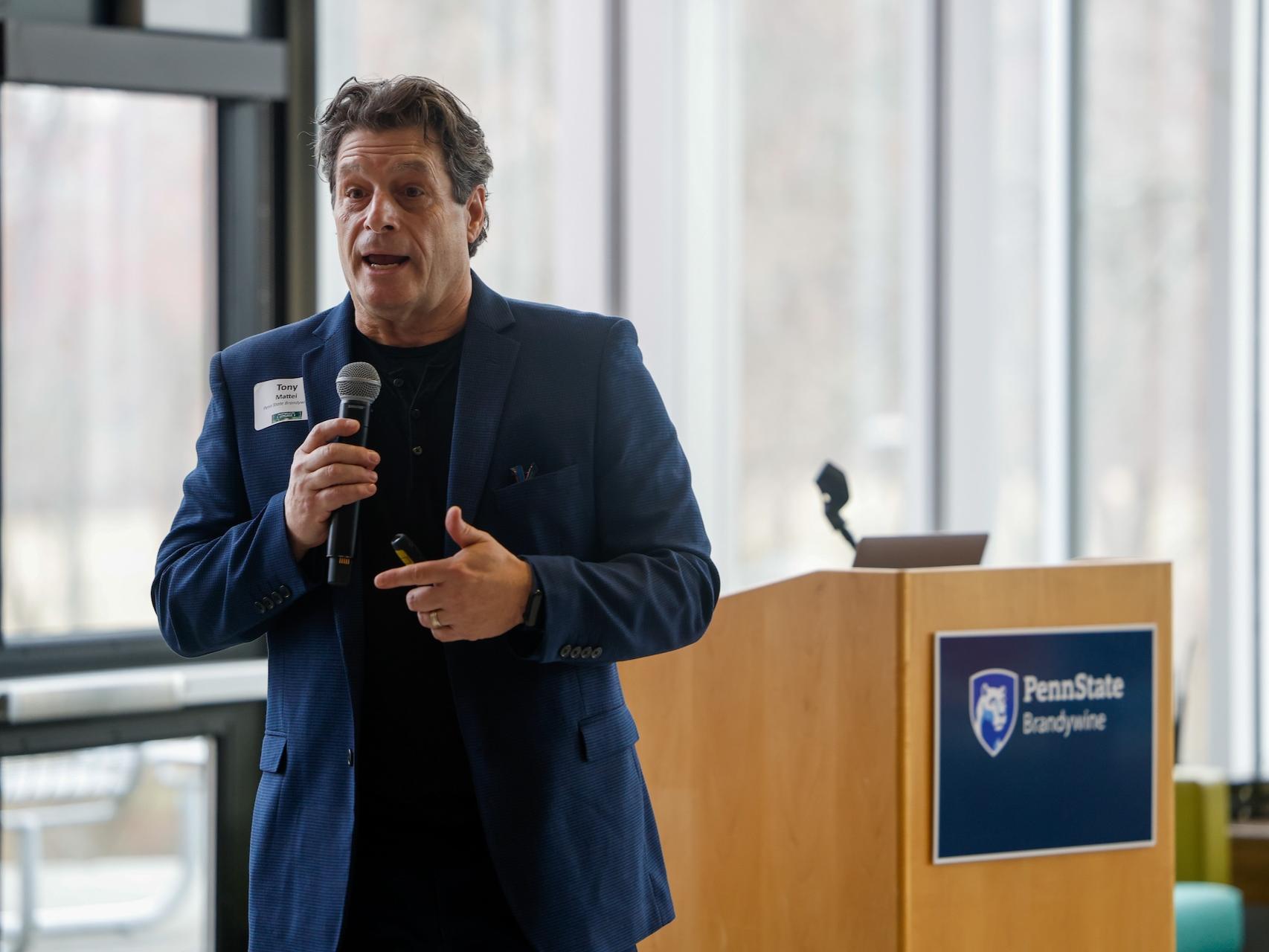 Tony Mattei speaking into microphone
