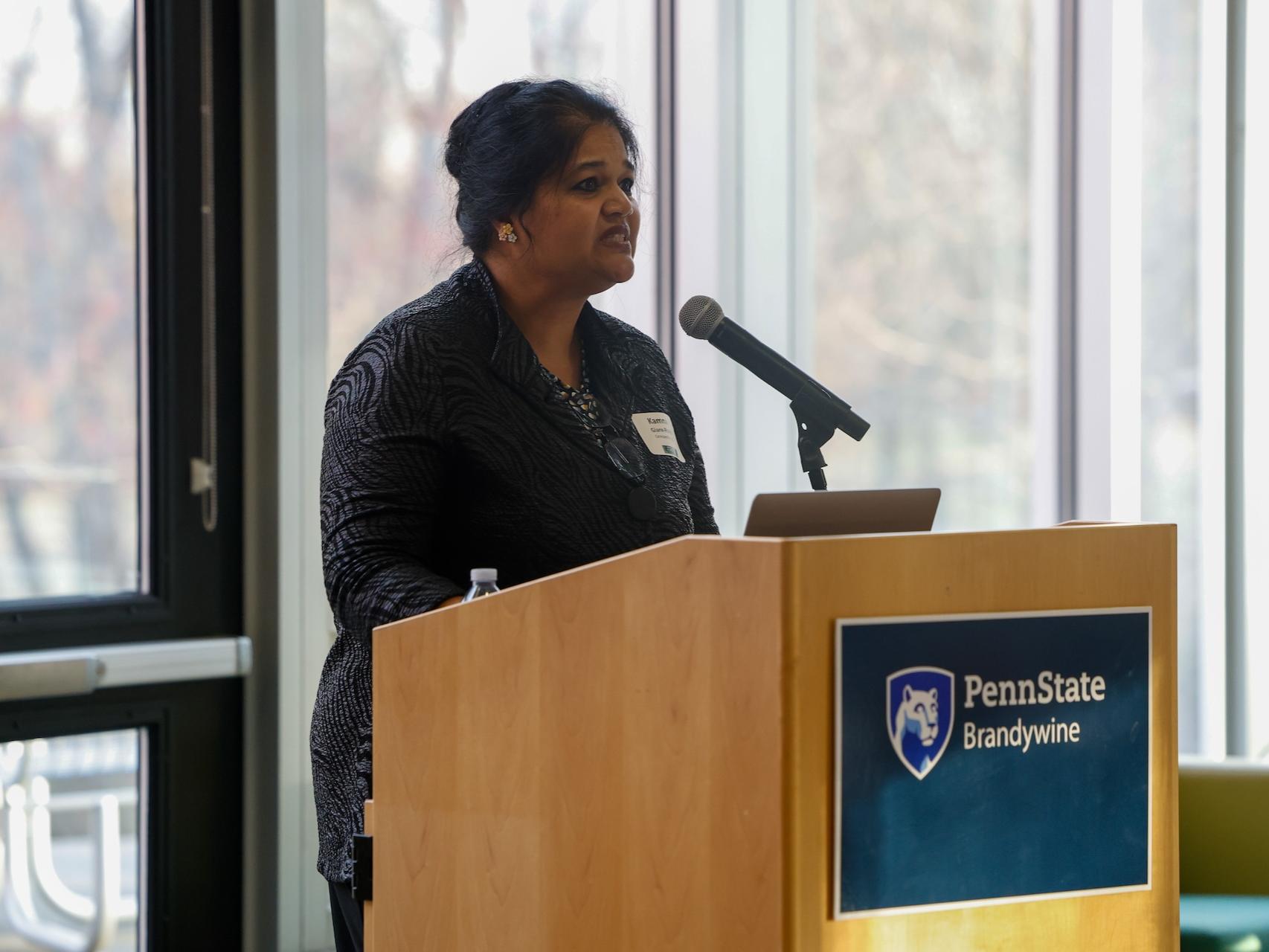 woman speaking into podium