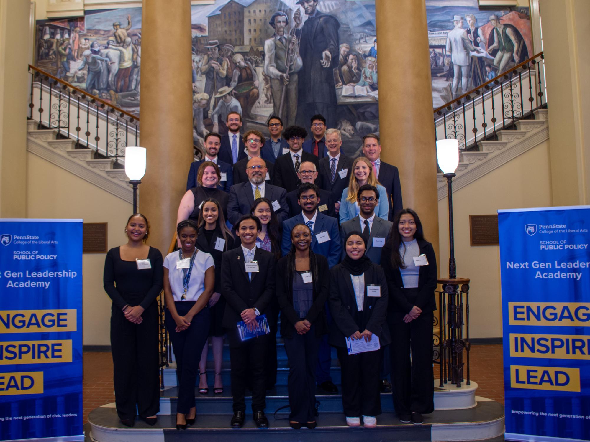 Muhammad Nazaruddin bin Mohd Salleh (first row, third from left) stands with his Next Gen Leadership Academy peers in four rows on steps inside Old Main.
