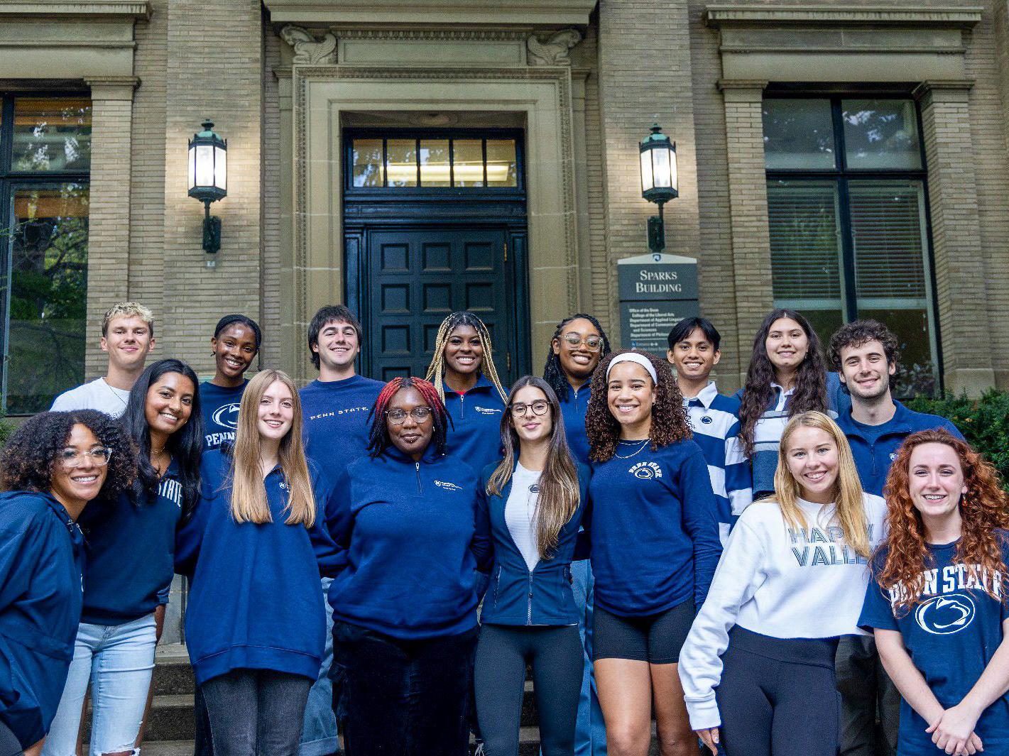 Muhammad Nazaruddin bin Mohd Salleh (second row, third from right) stands with the rest of the Liberal Arts peer advisers on steps outside Sparks Building.