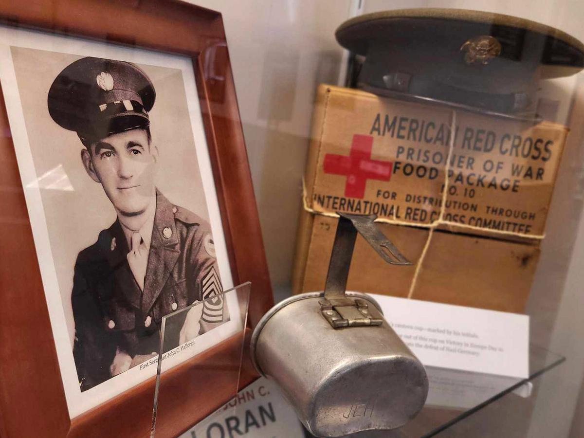Personal items belonging to John C. Halloran now on display in the Smith Building. including a WWII-era photo, a canteen, and a American Red Cross food package.