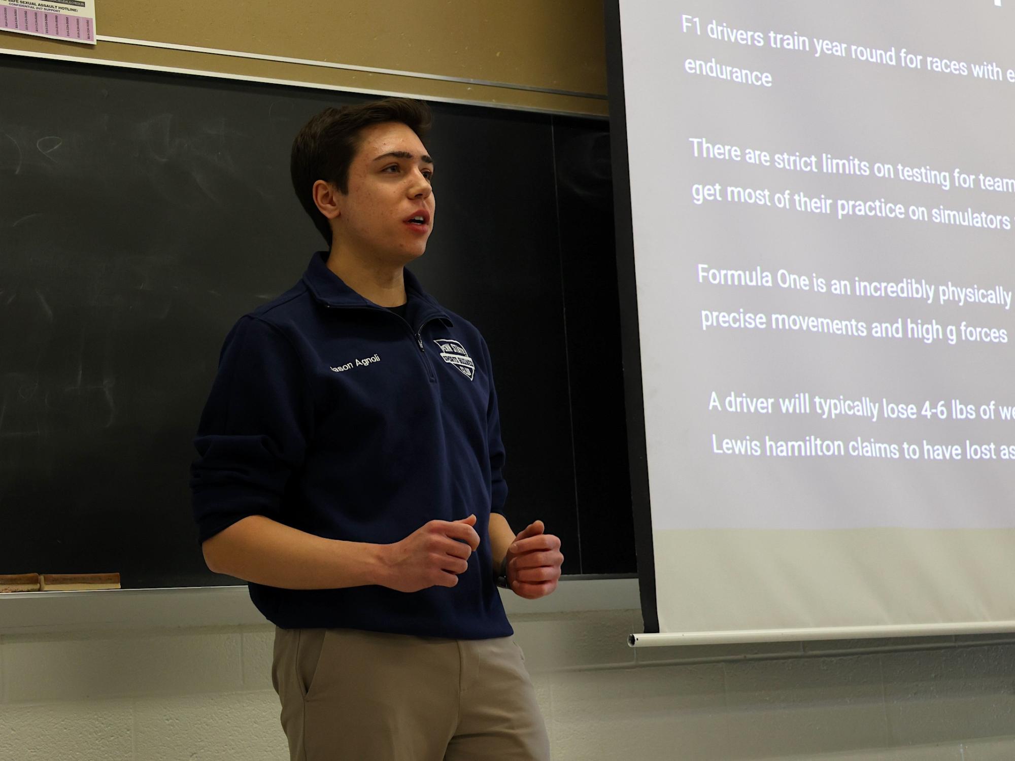 Jason Agnoli standing in front of projector screen