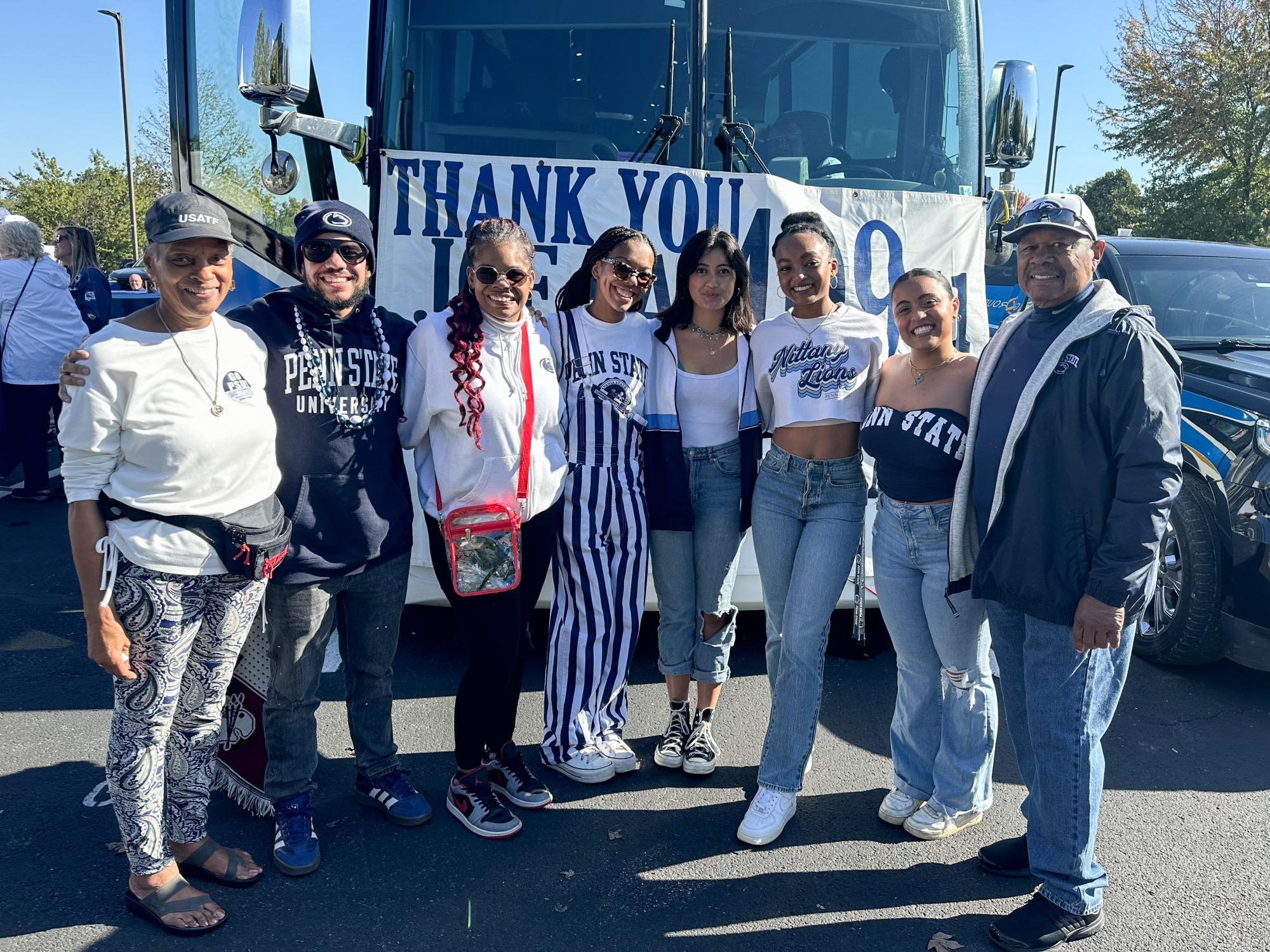 Laci Campbell (fourth from left) stands in a row with her family and roommates in the parking lot of Beaver Stadium before a Penn State football game.