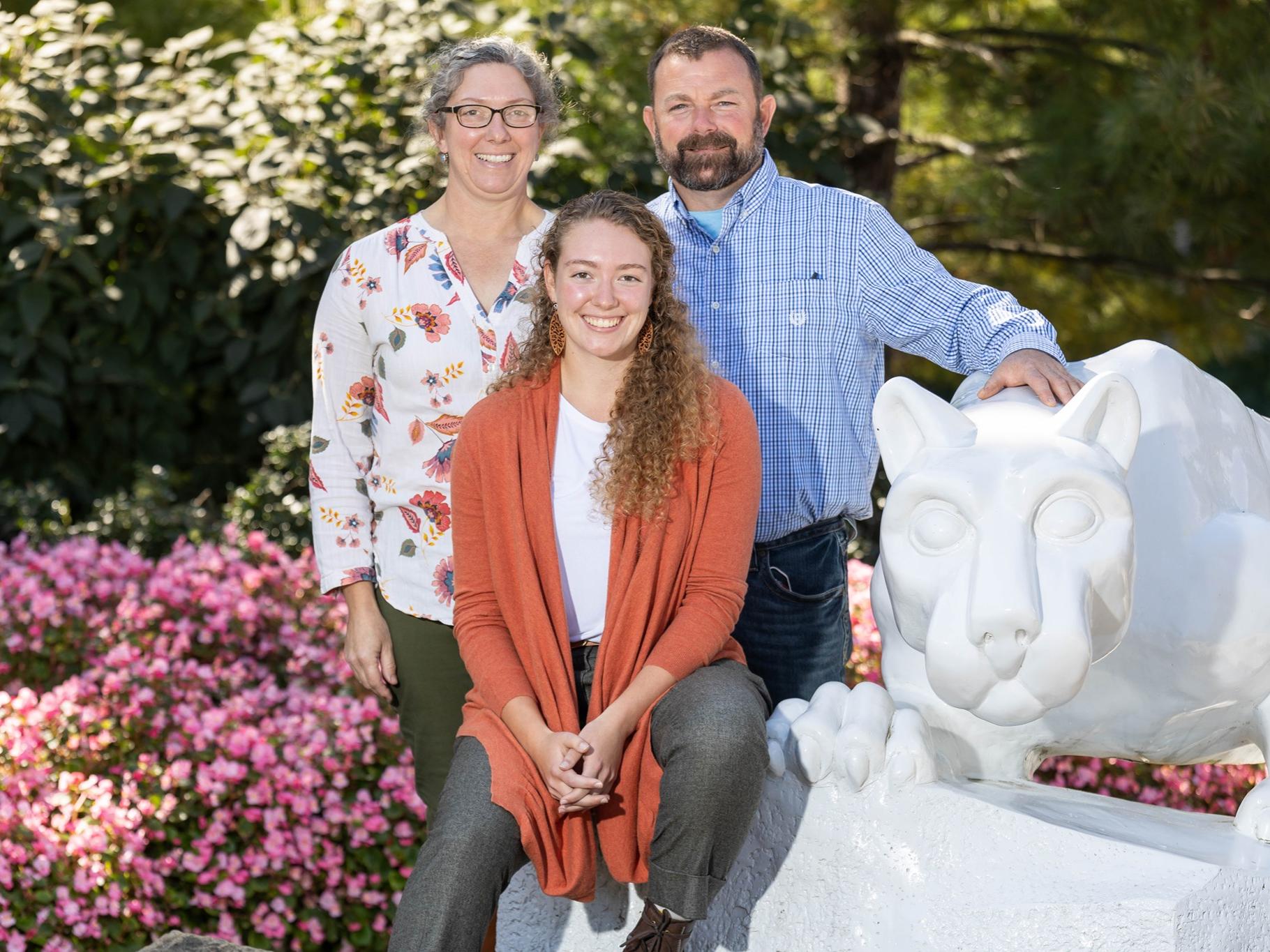 Landis and her parents pose with the Nittany Lion Shrine