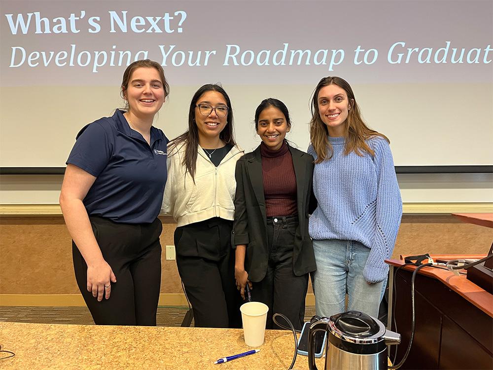 Four students look at camera
