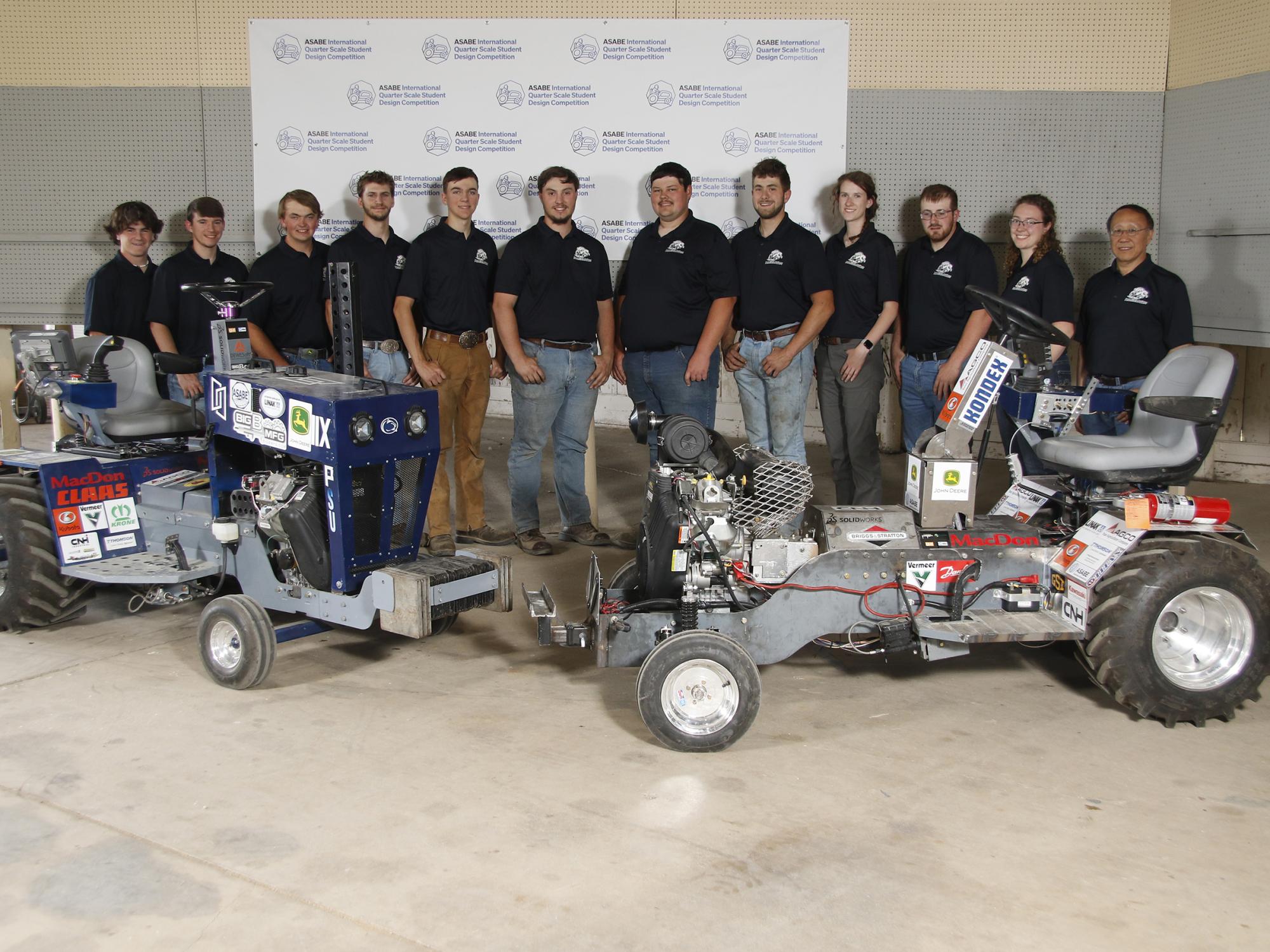 The Penn State Pullers in front of the tractor they created